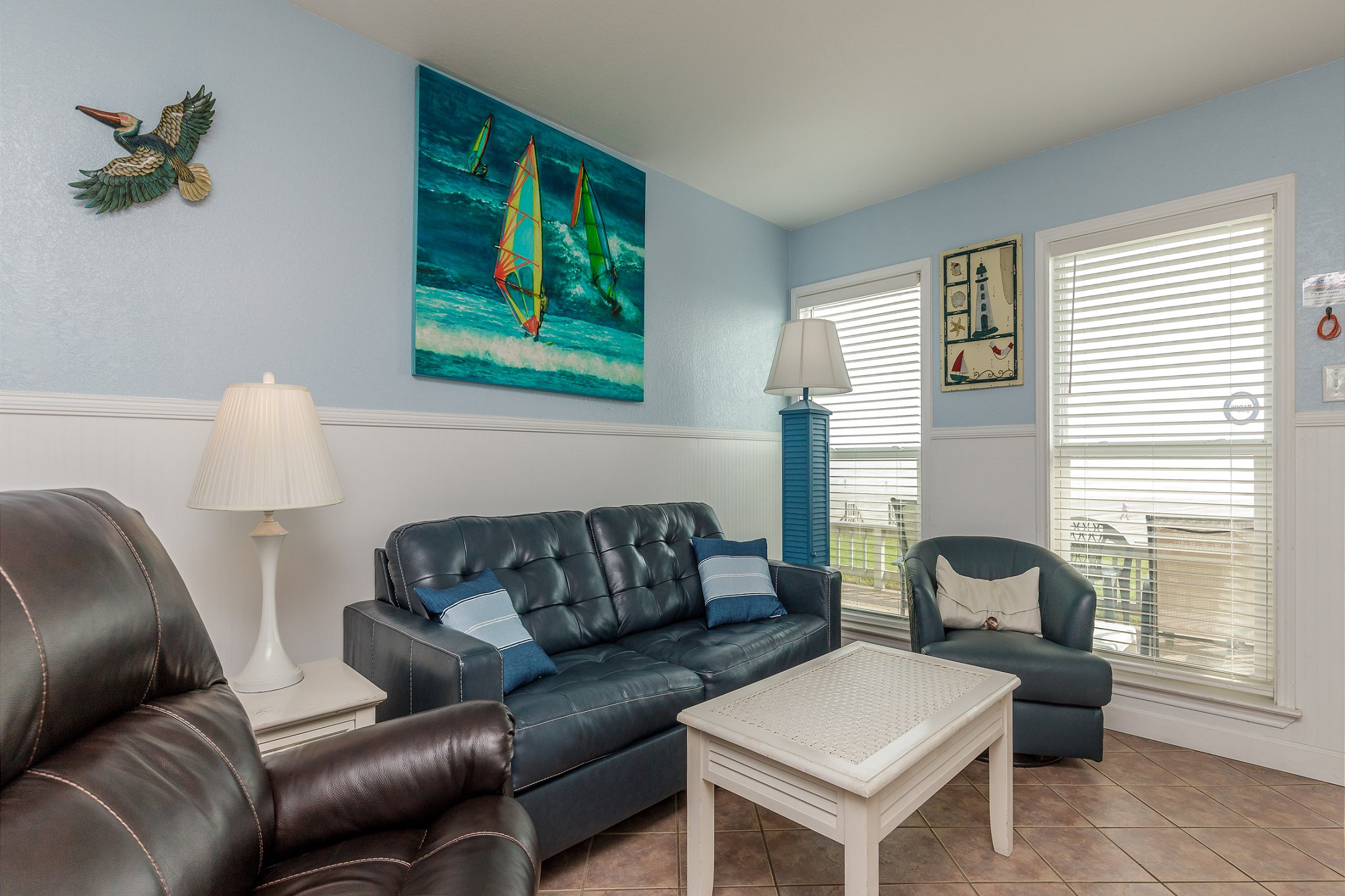 Newly updated living area with queen size sleeper sofa and large windows to view the beautiful beach 