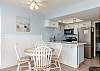 Dining table with seating for four over looking the kitchen