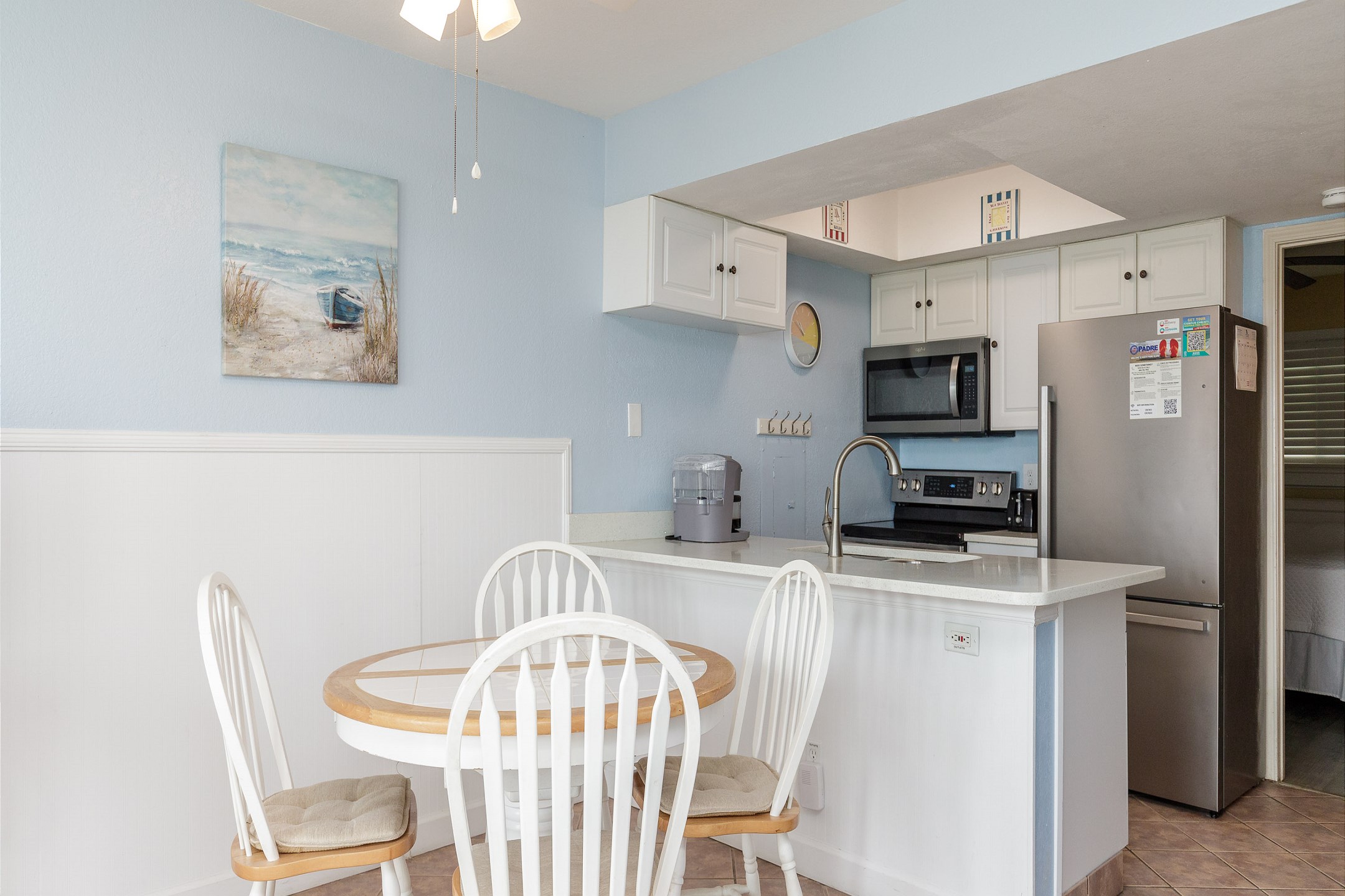 Dining table with seating for four over looking the kitchen