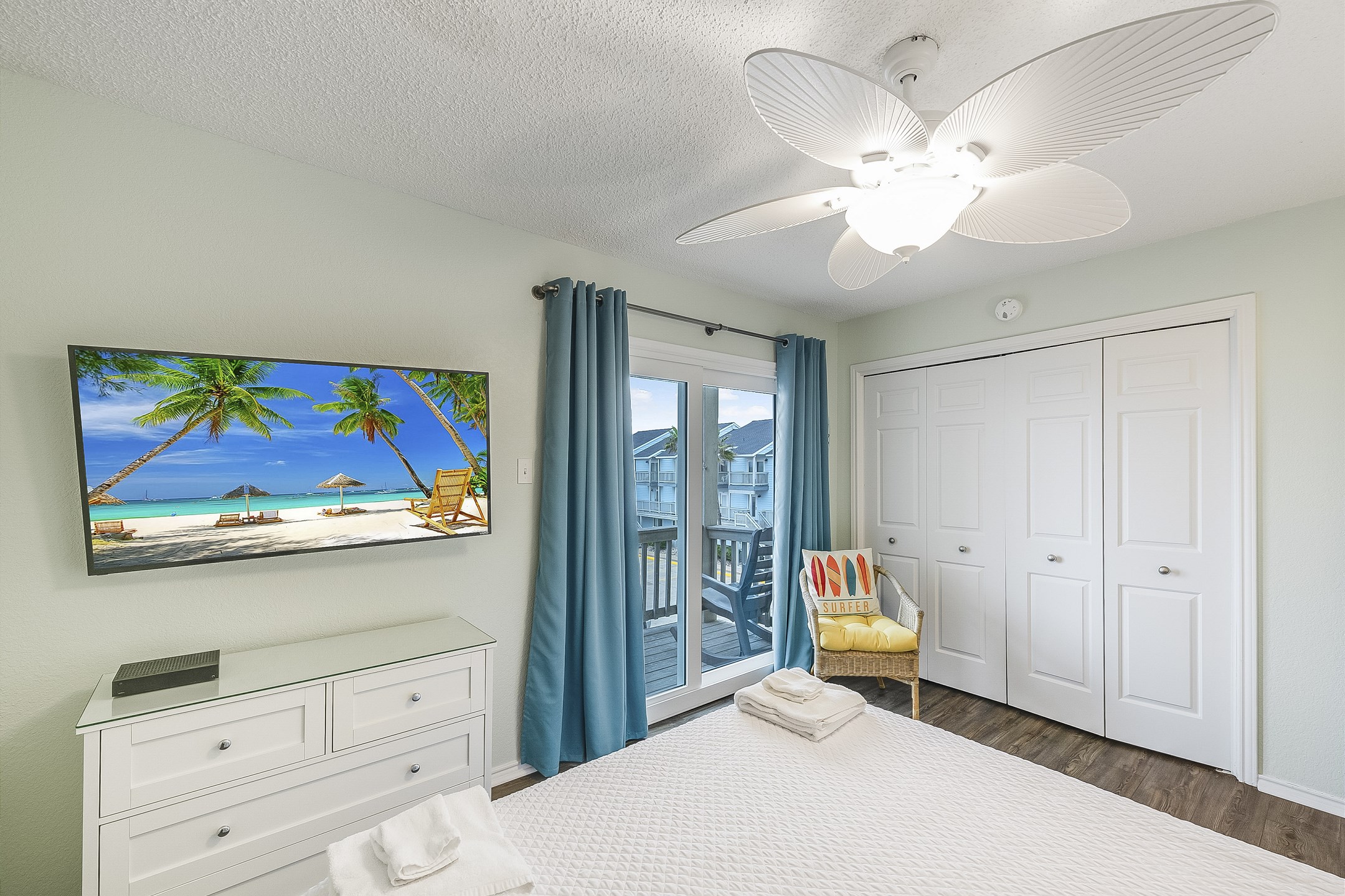 Second bedroom on the second floor with queen size bed, new headboard, flat screen TV and a private balcony