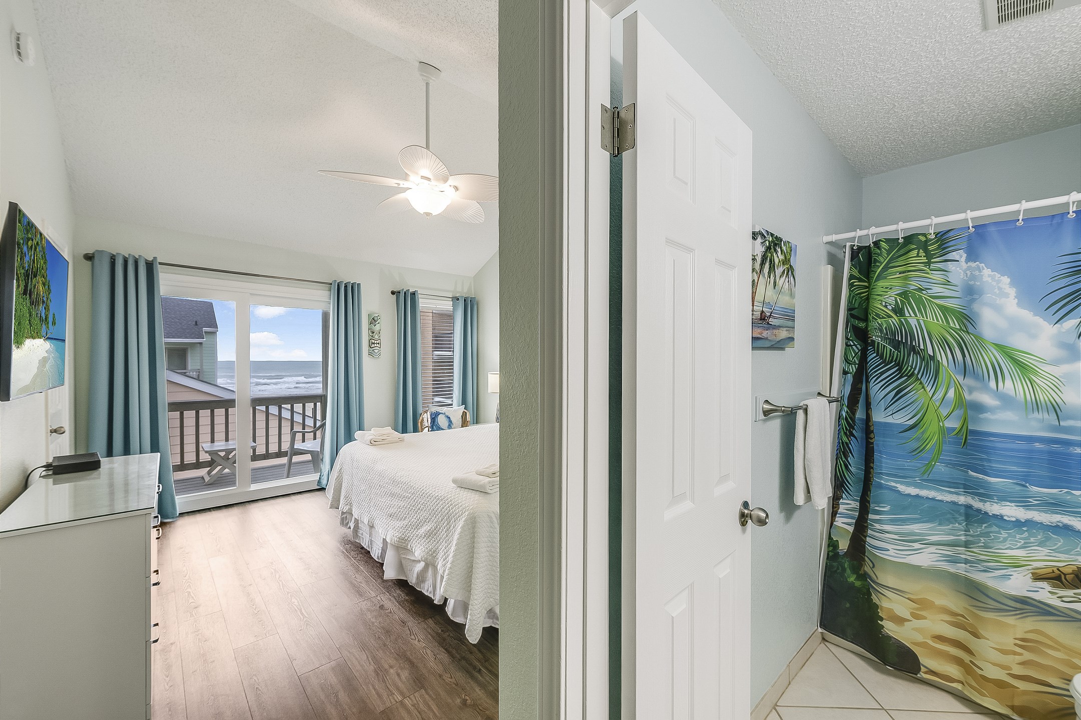Primary bedroom on the second floor with king size bed, new headboard, flat screen TV, private bathroom and a lovely private balcony that offers unbeatable views of the ocean and pool 