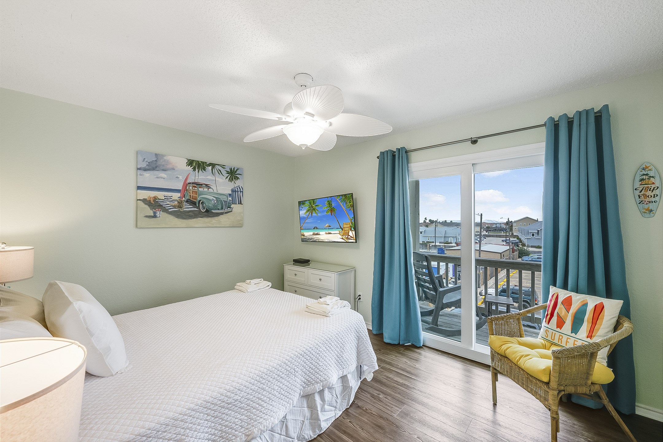 Second bedroom on the second floor with queen size bed, new headboard, flat screen TV and a private balcony