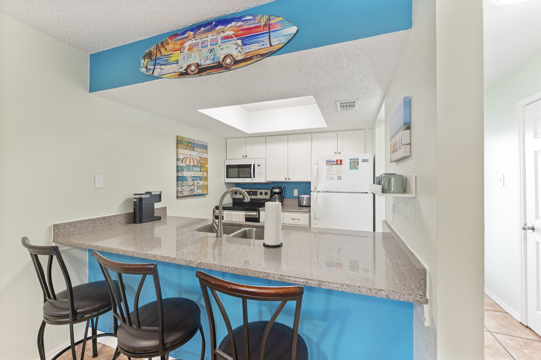 Cozy breakfast bar with seating for three that offers an overview of the kitchen space 