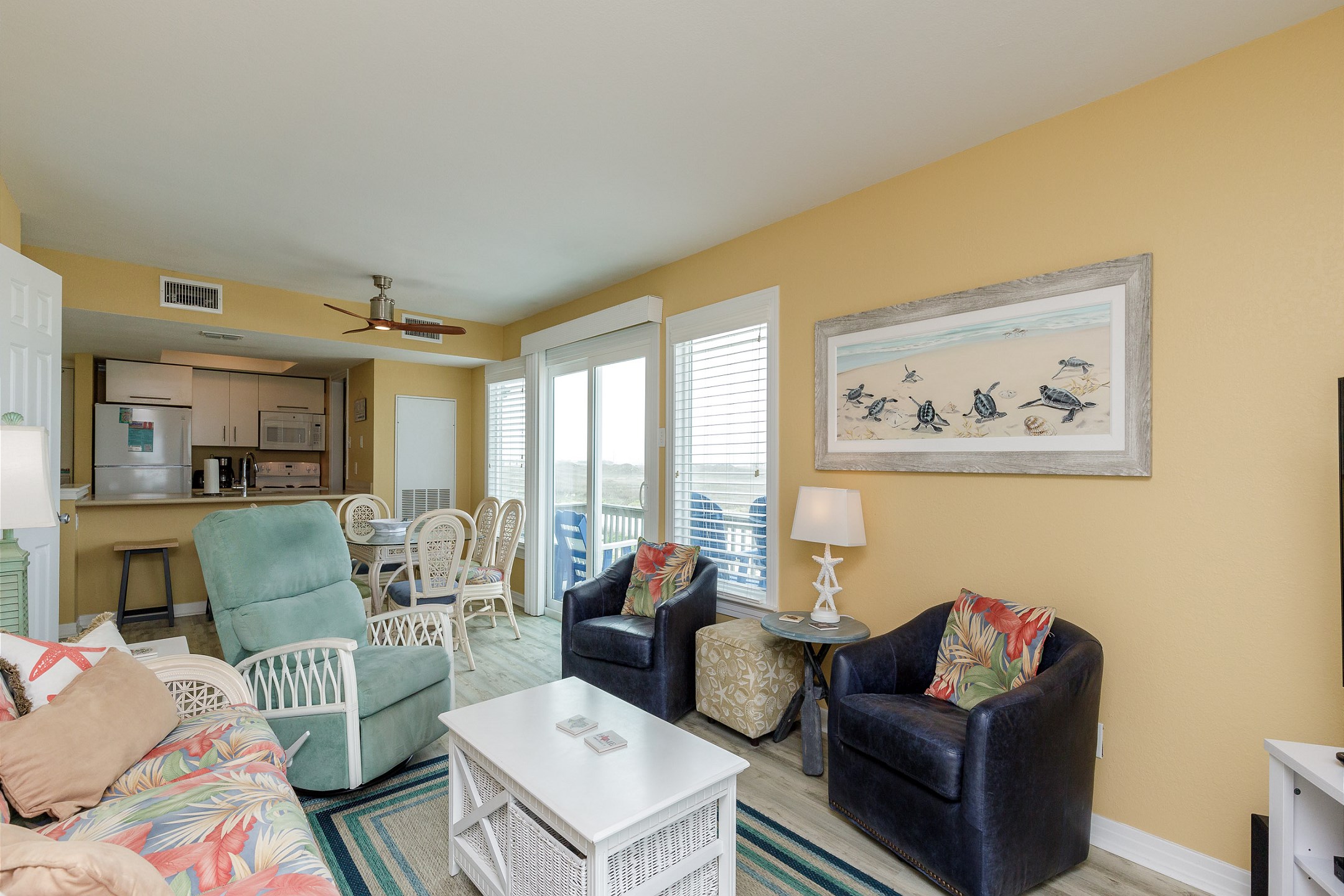 Spacious living area with two balconies with beachfront views
