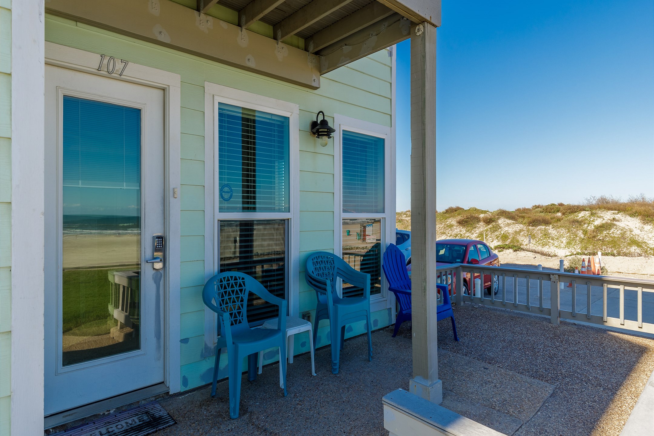 Inviting corner patio space with chairs to watch the waves - front entrance with coded lock for extra security 