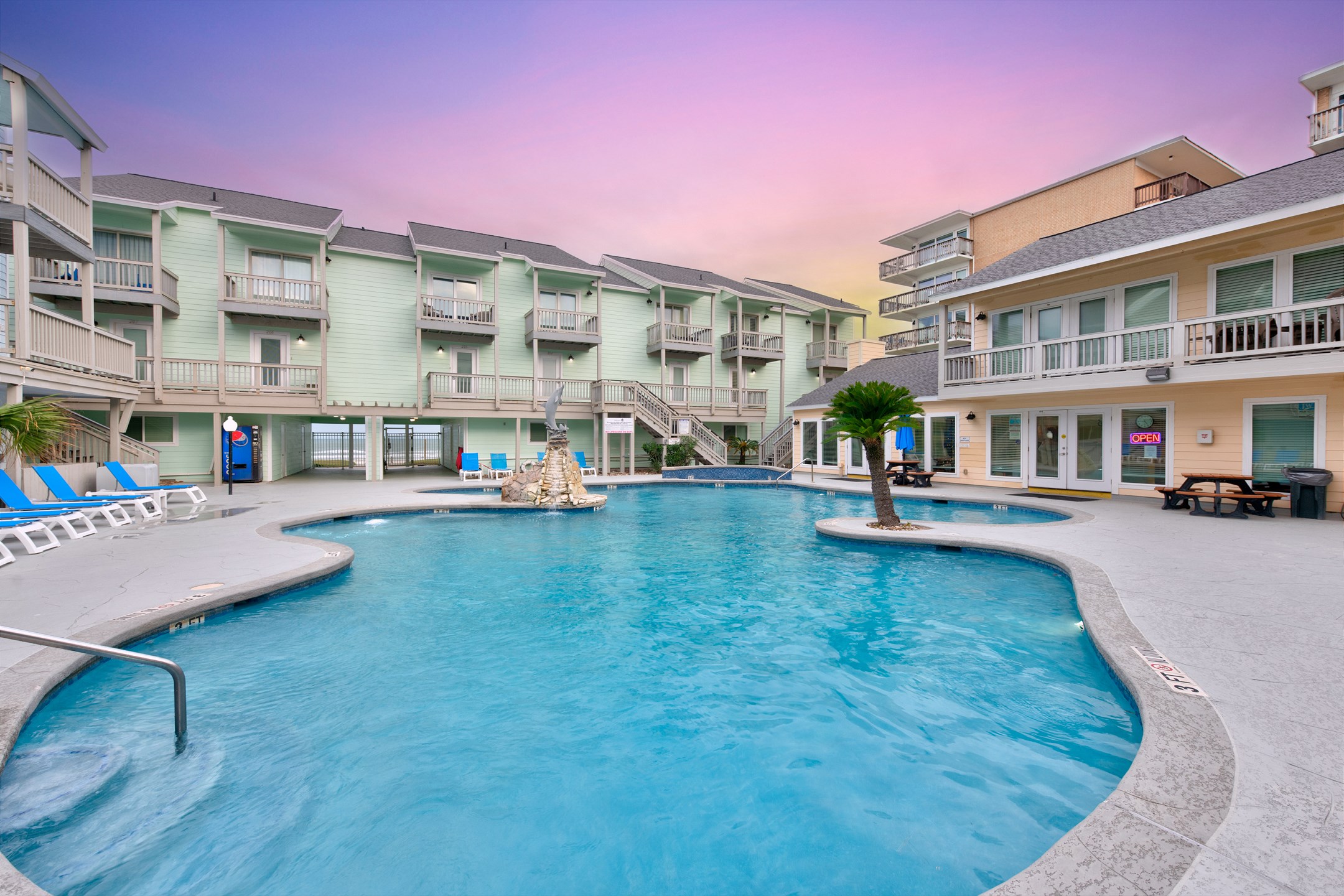 Admire the shimmering El Constante pool—perfect for a refreshing dip after a sun-soaked day of beach adventures and coastal fun.