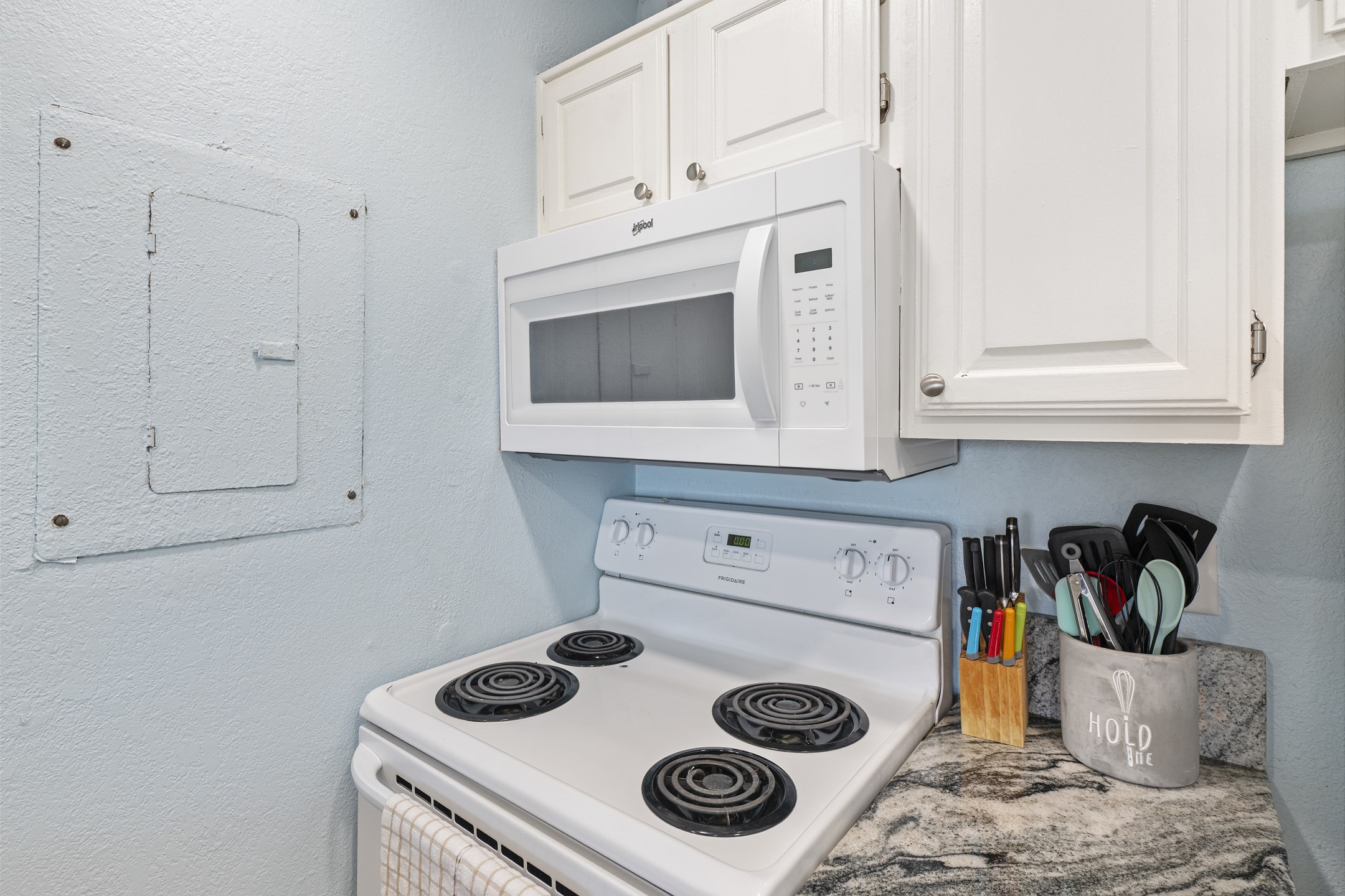Fully equipped kitchen with coffee maker, toaster, cookware, dinnerware, and other kitchen essentials provided