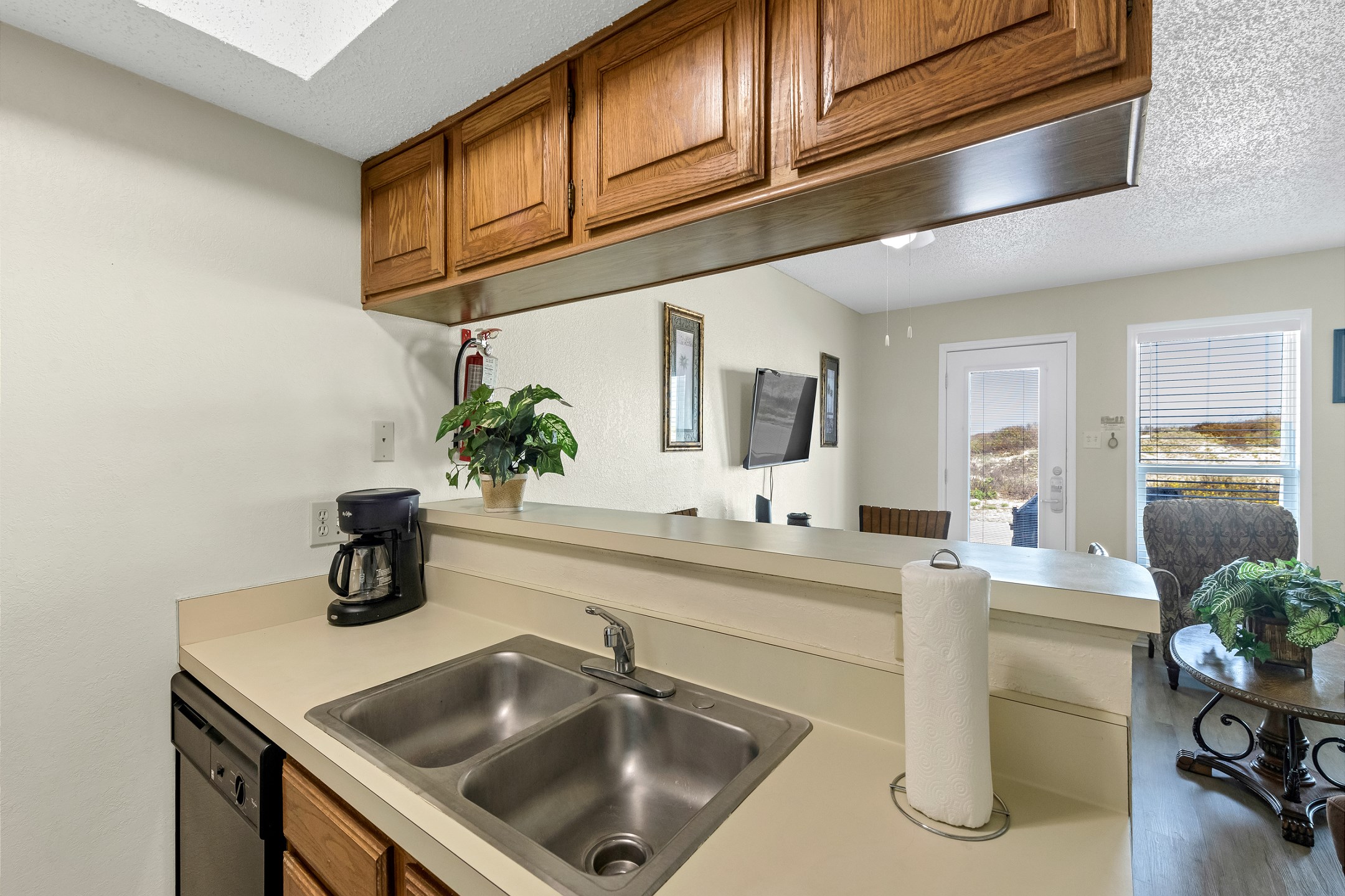 Kitchen area with a bar that overlooks living area 