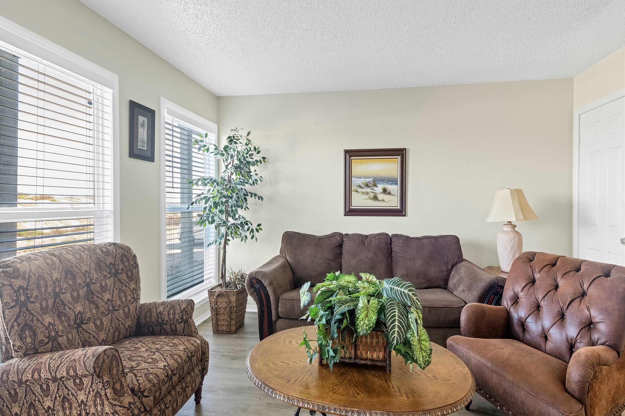 Unwind in the living area with cozy furniture with natural light shinning in
