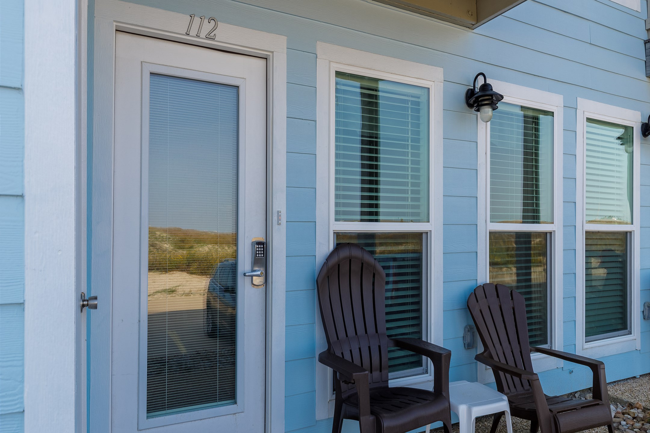 Front patio with chairs and entryway with coded lock for added security
