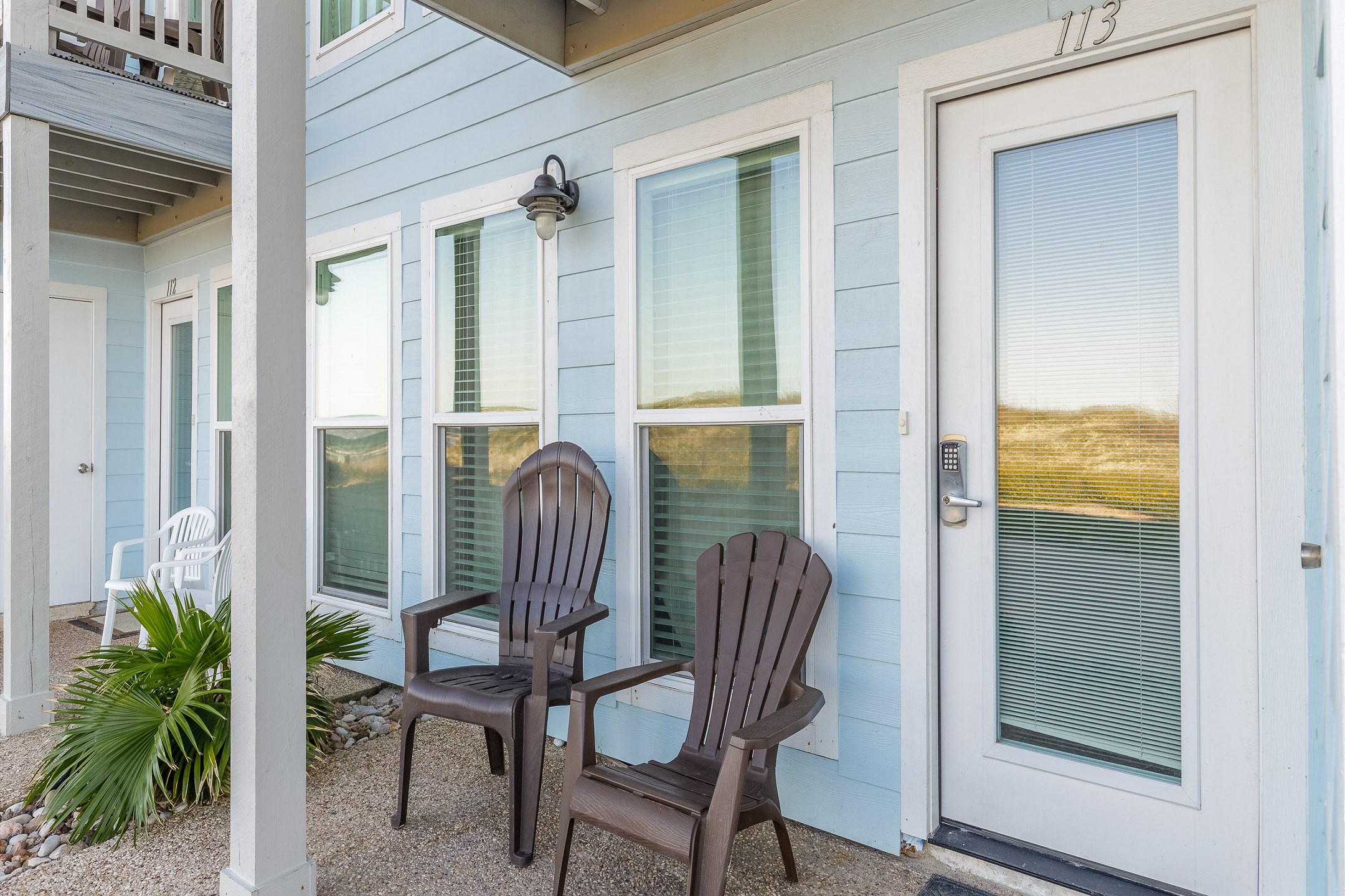 Lovely patio space with cozy seating and front door with coded door lock for added security