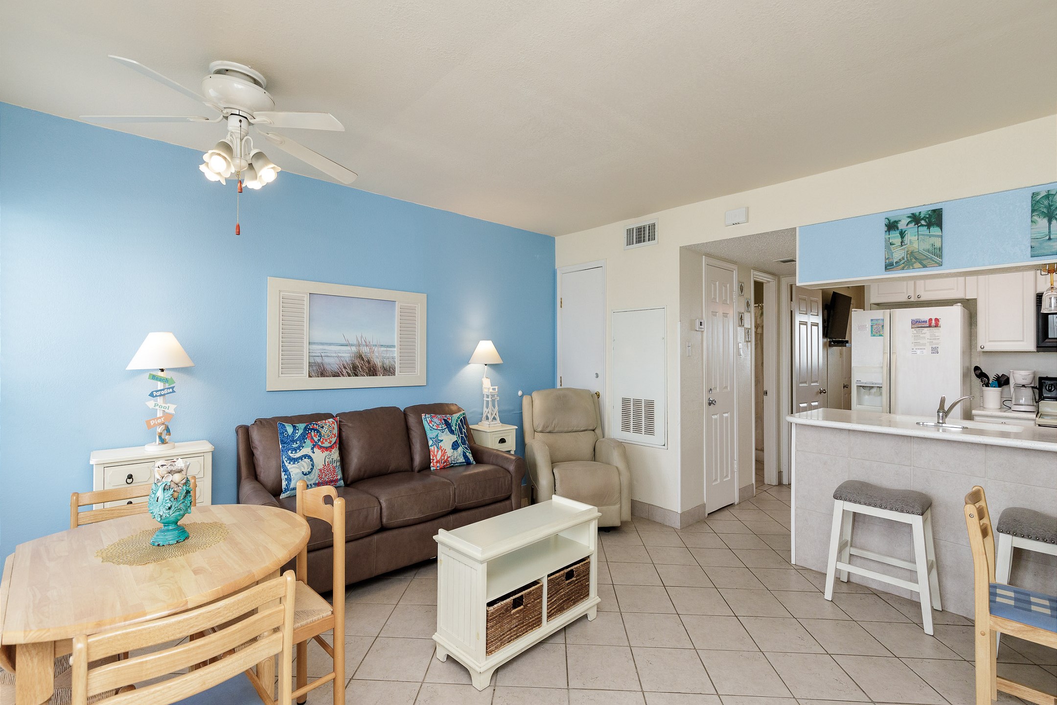 The kitchen, dining, and living areas blend seamlessly for a bright and airy feel