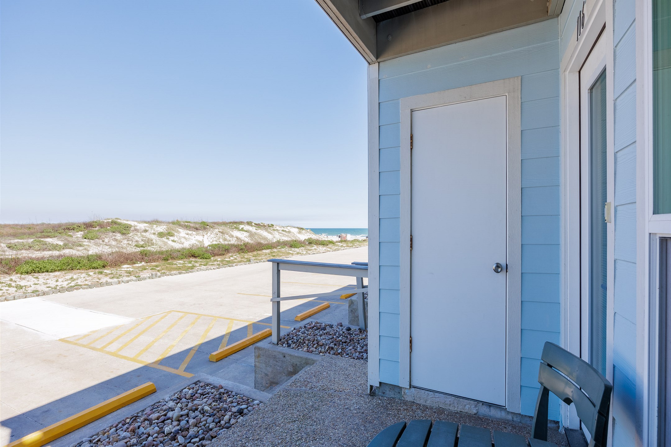 Front exterior of property, beach is just steps away 