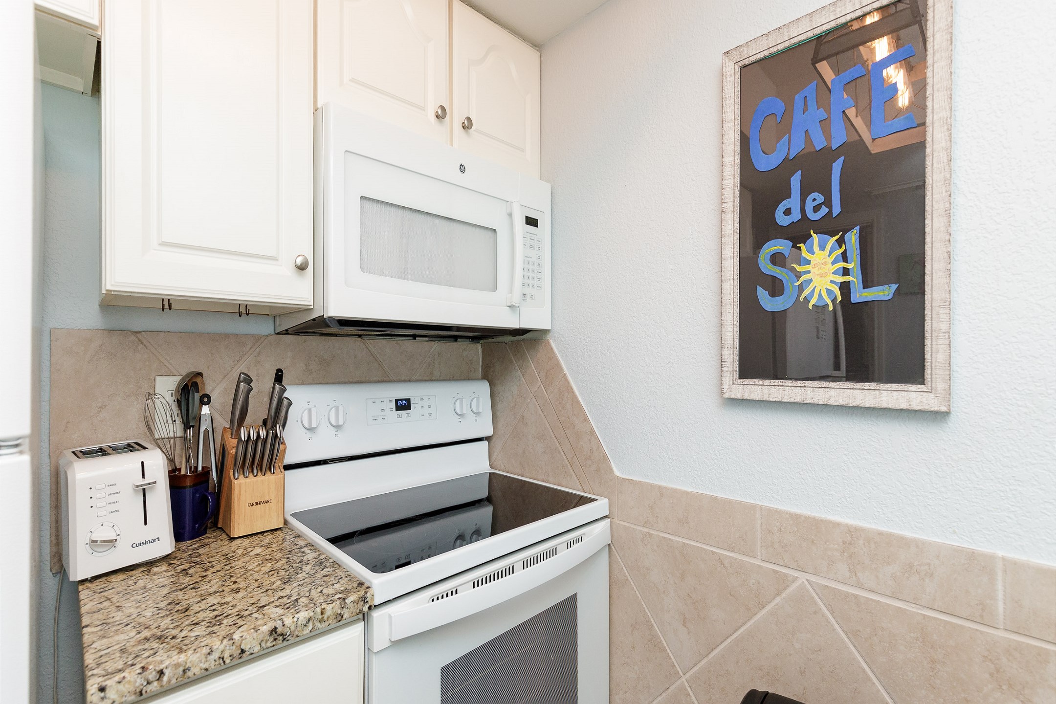 Coffee maker, toaster, cookware, dinnerware, and other kitchen essentials provided