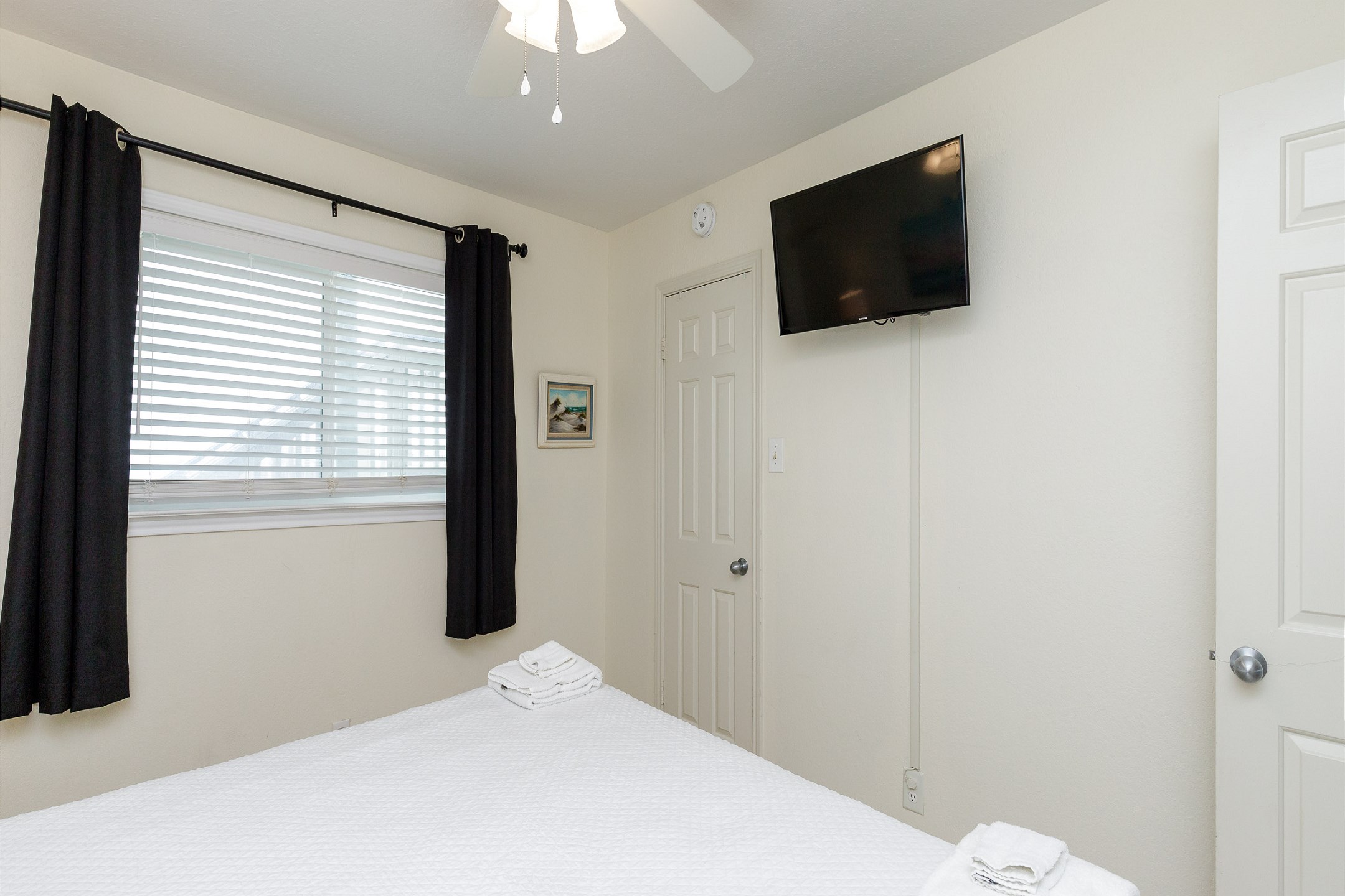 Master bedroom with king size bed and flat screen TV