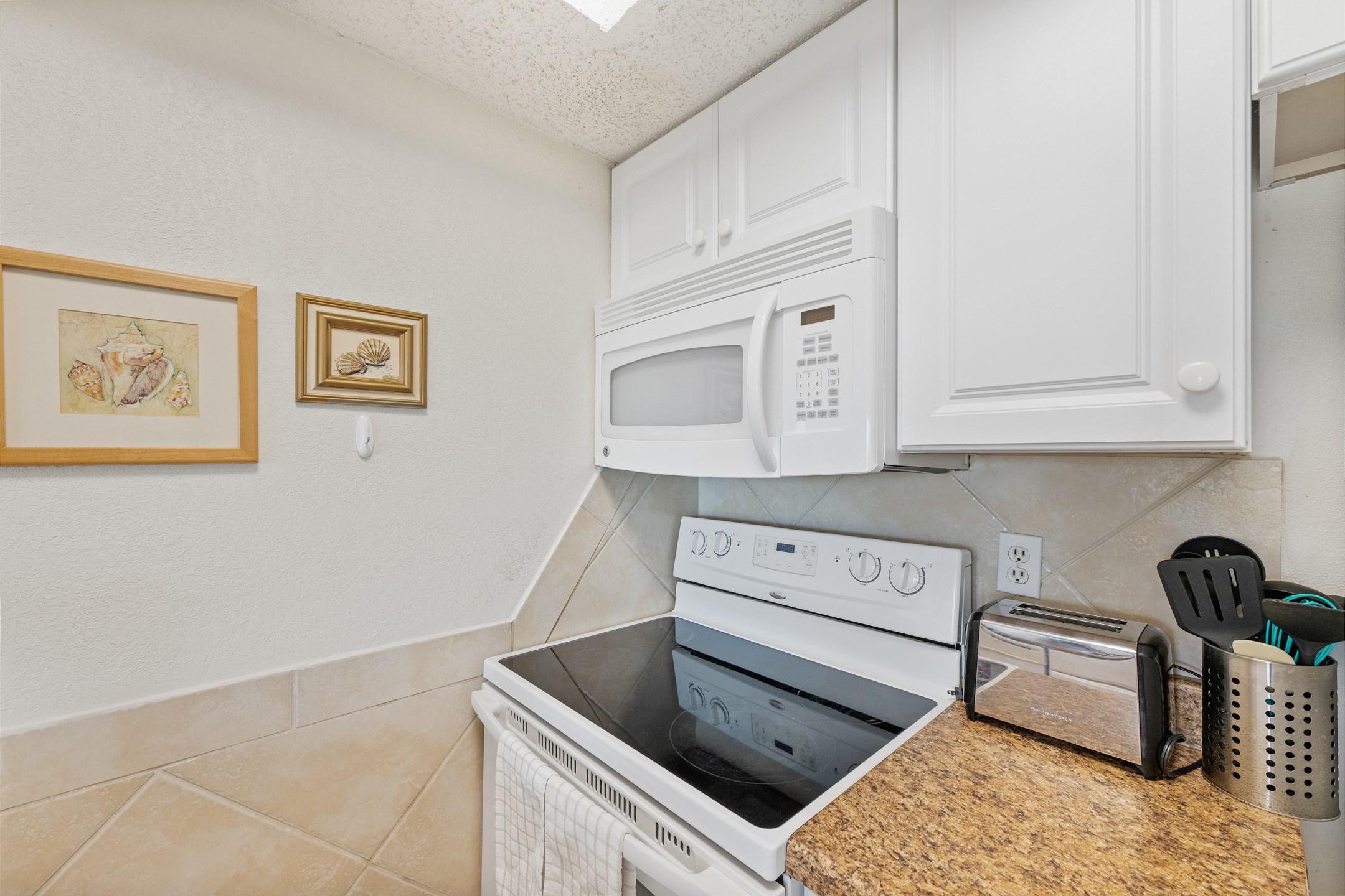 Coffee maker, toaster, cookware, dinnerware, and other kitchen essentials provided