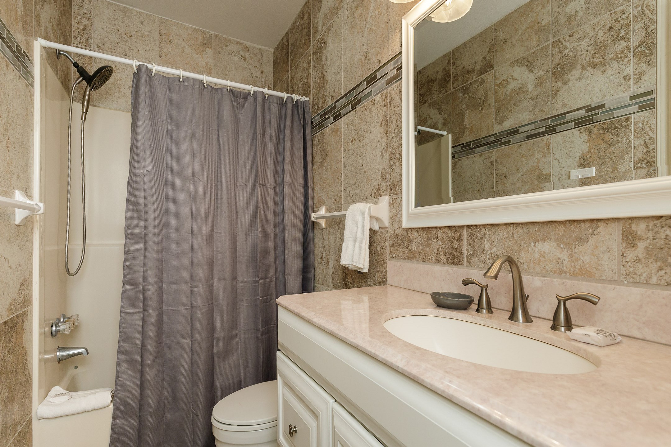 Guest bathroom with tub and shower 