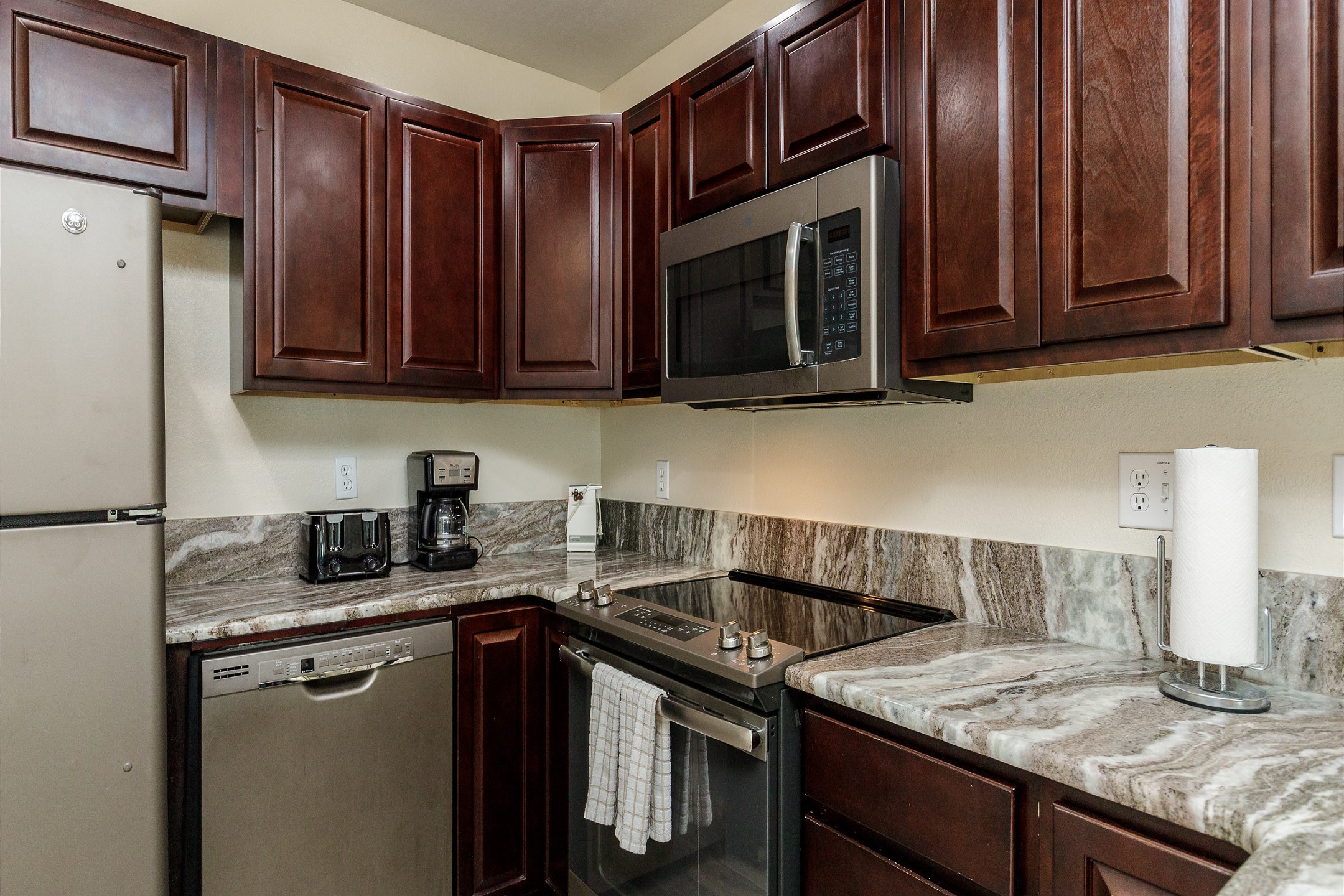 Coffee maker, toaster, cookware, dinnerware, and other kitchen essentials provided