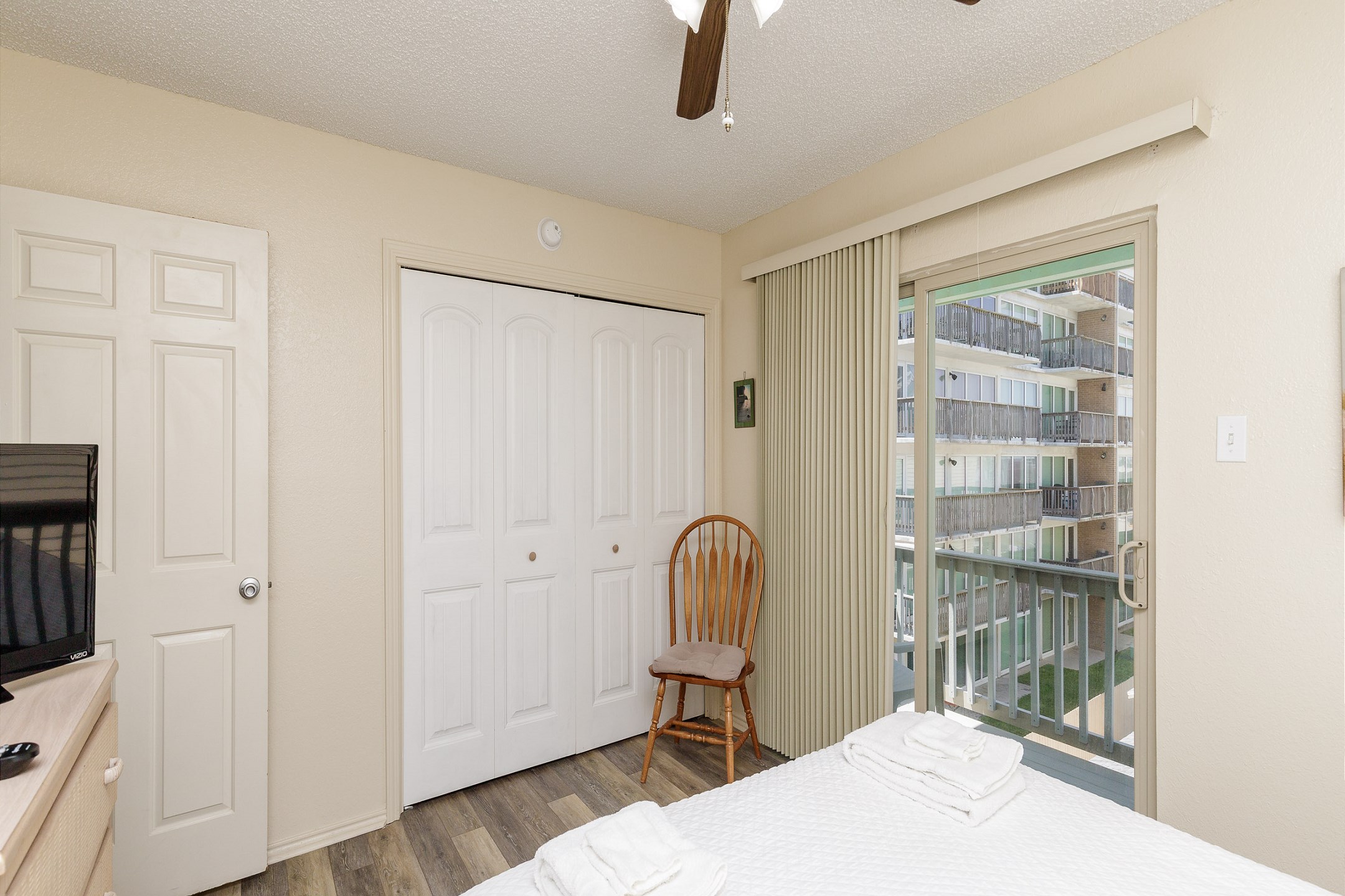 Second bedroom on the second floor with queen size bed, private balcony, and flat screen TV