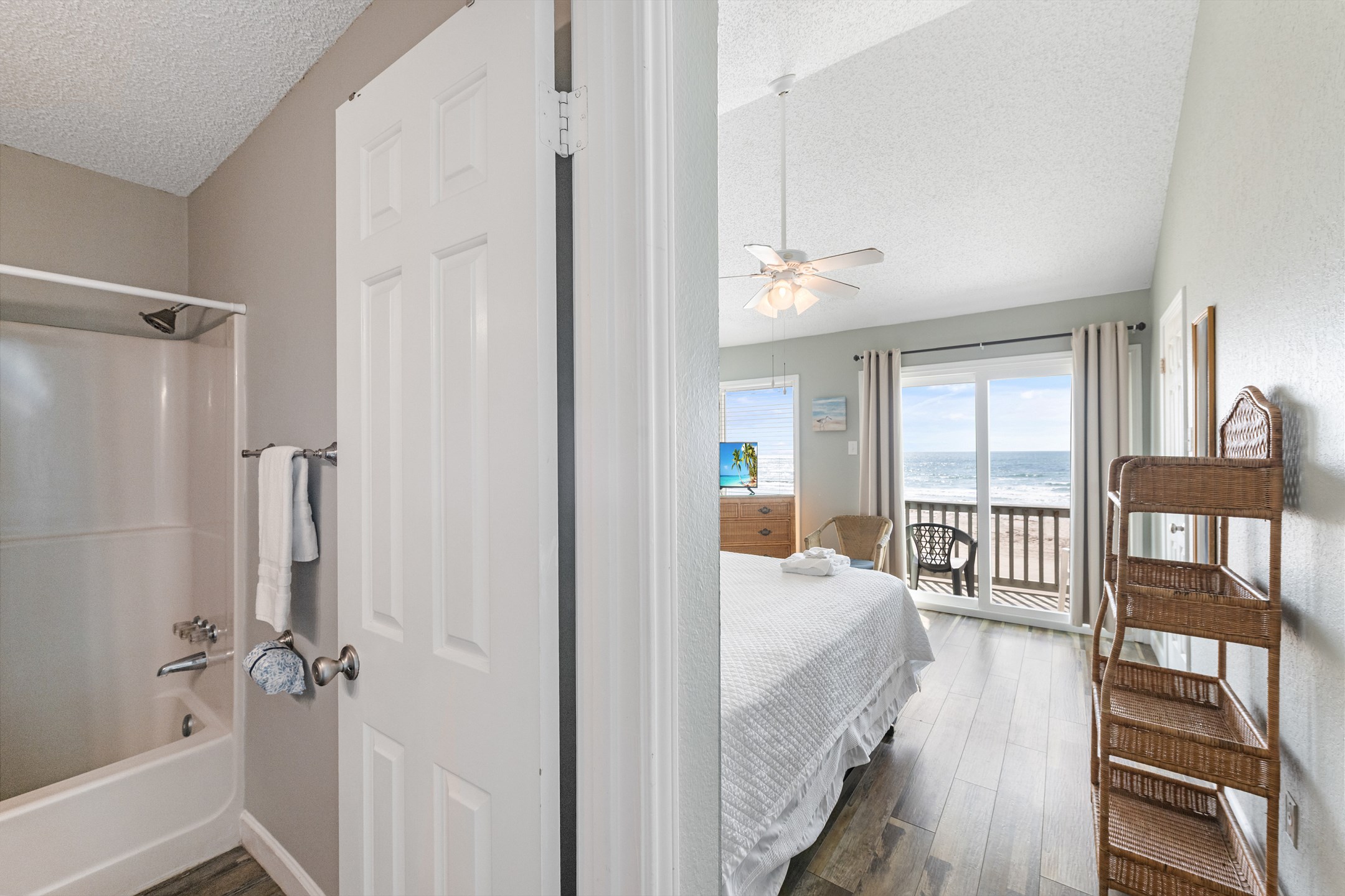 Master bedroom with king size bed, private bathroom, flat screen TV and private balcony overlooking the beach 