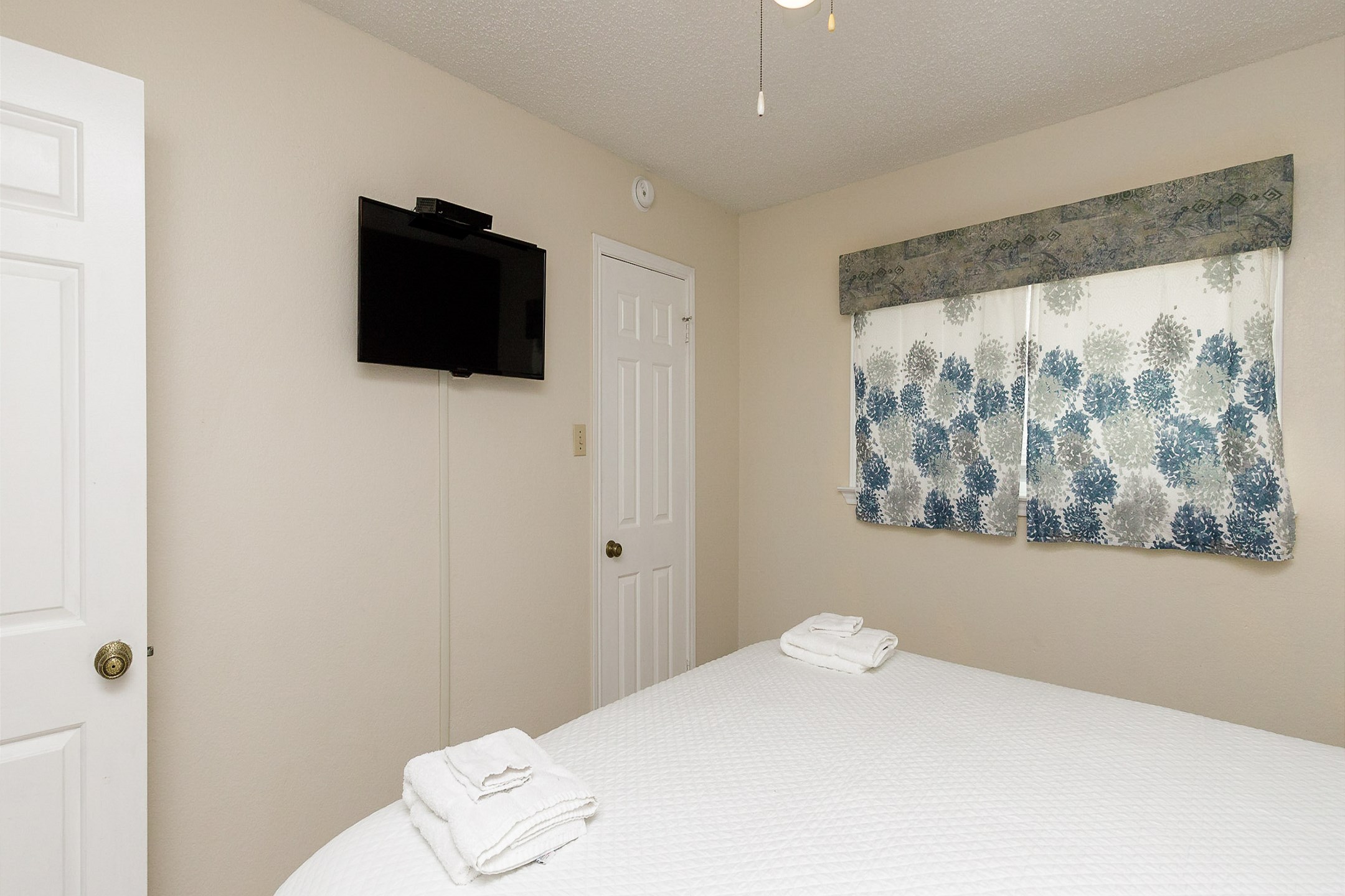 Master bedroom with king size bed and flat screen TV