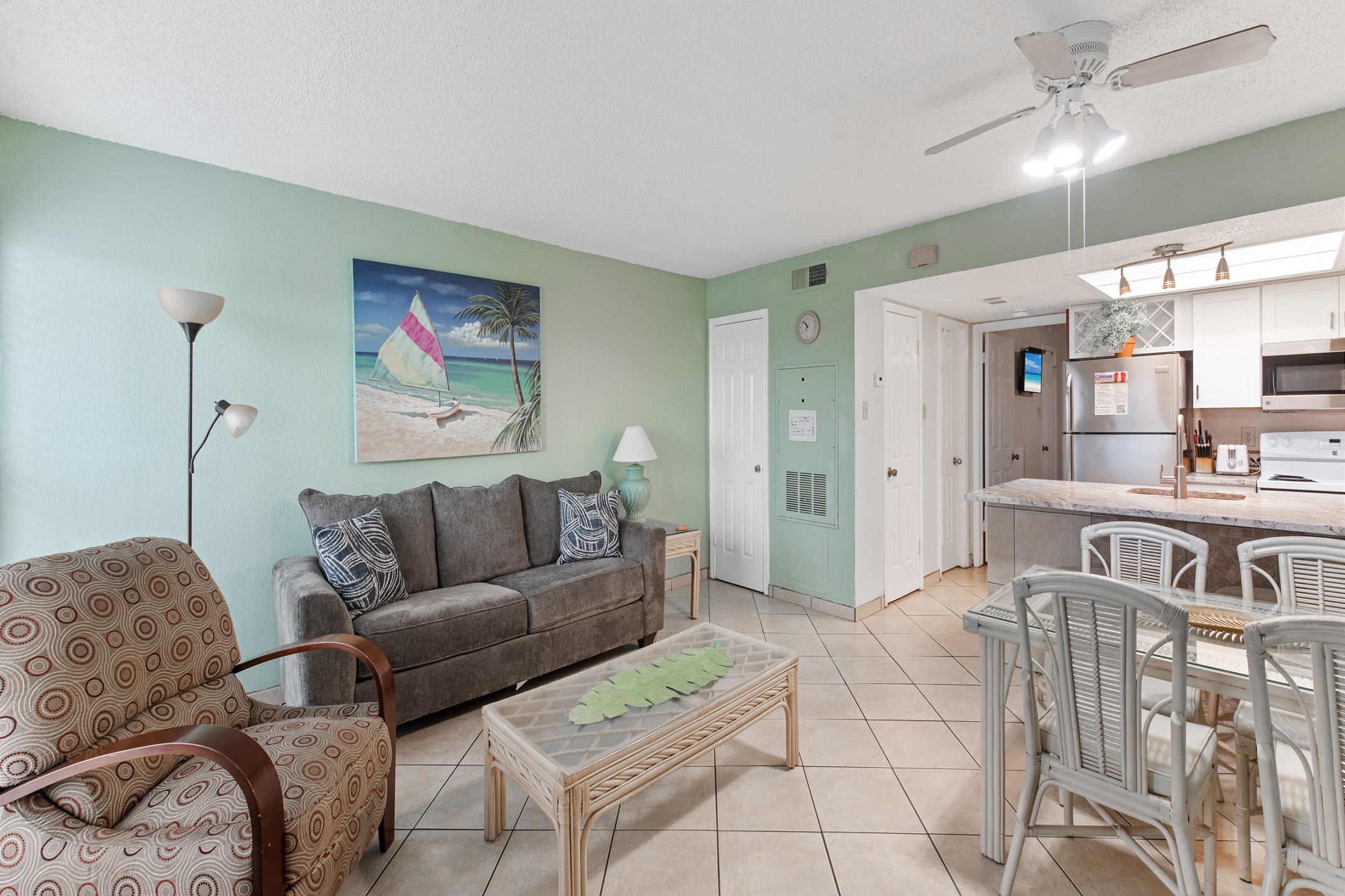 Expansive social hub with a well-equipped kitchen, formal dining area, and plush living room with new furniture 