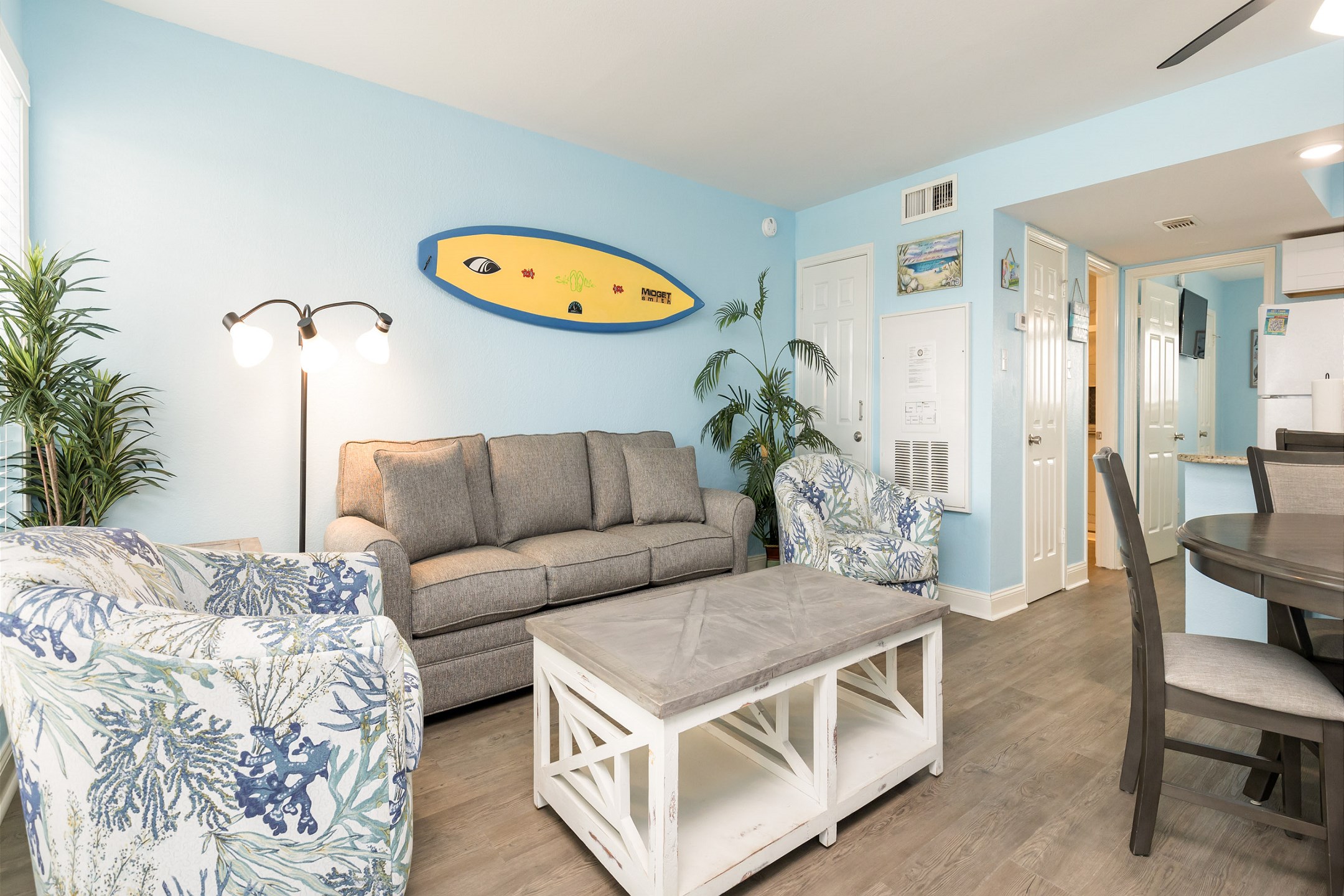 Open concept living area with queen size sleeper sofa and flat screen TV 