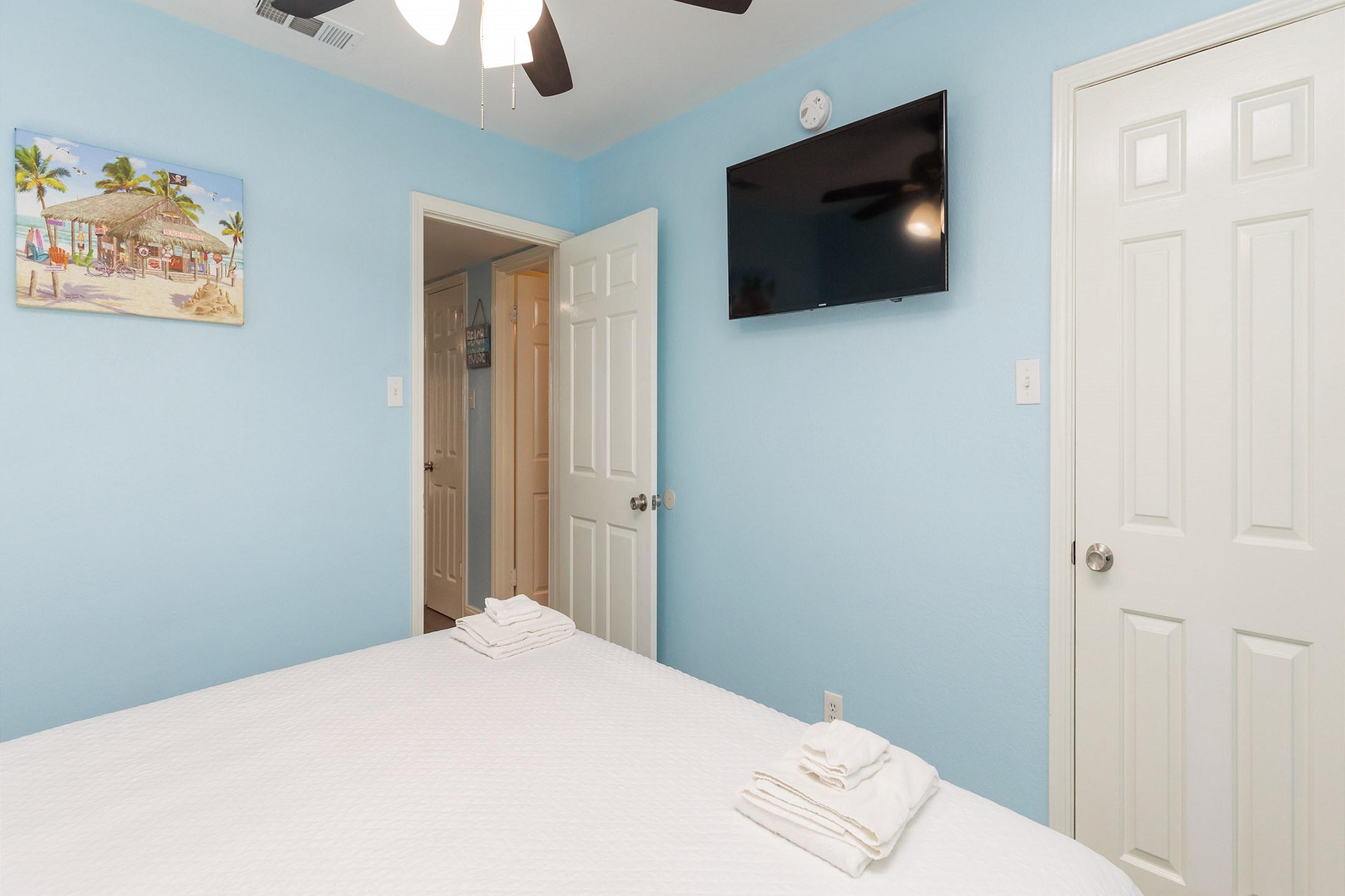 Master bedroom with king size bed and flat screen TV 