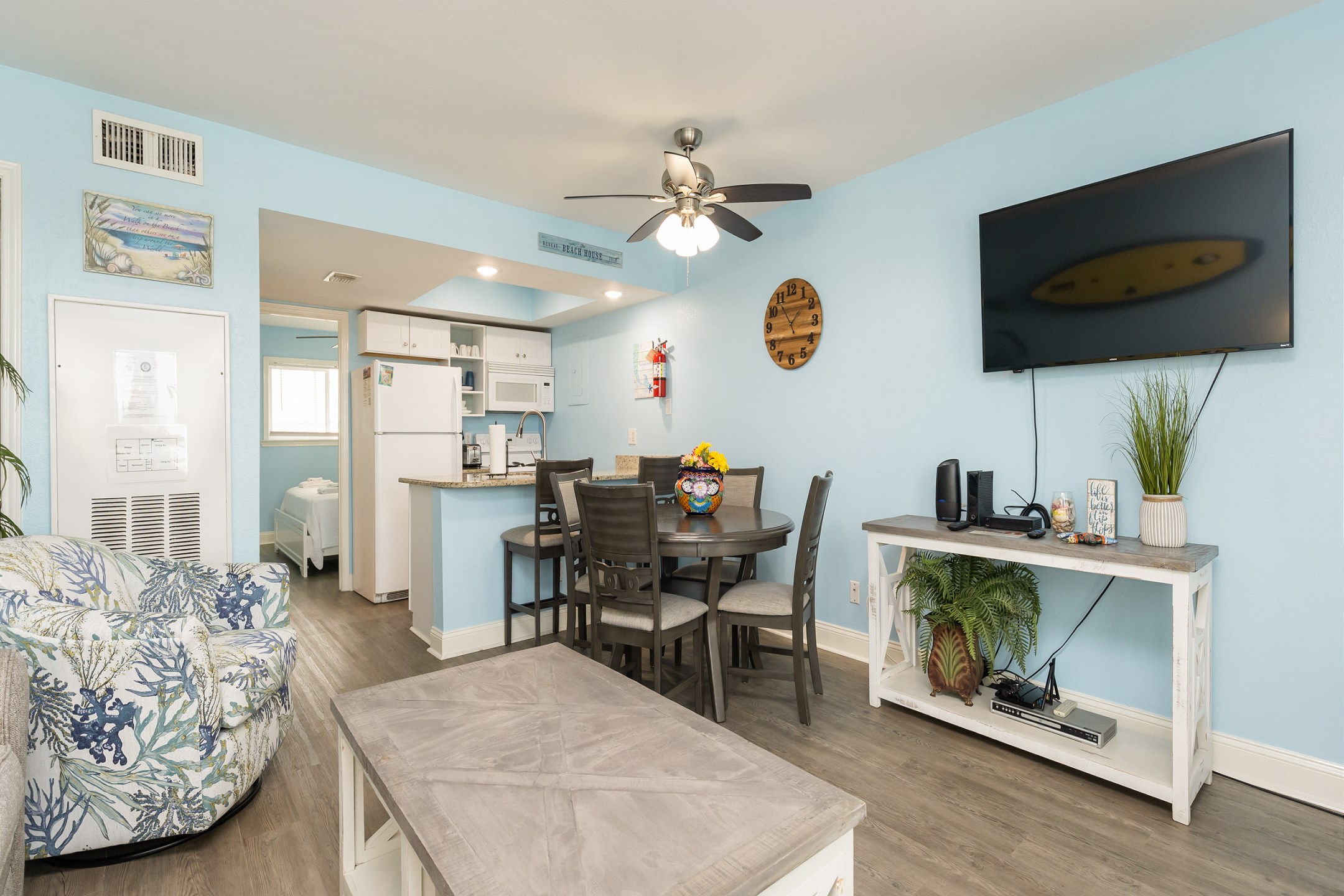 Open-concept living, dining, and kitchen area filled with coastal vibes