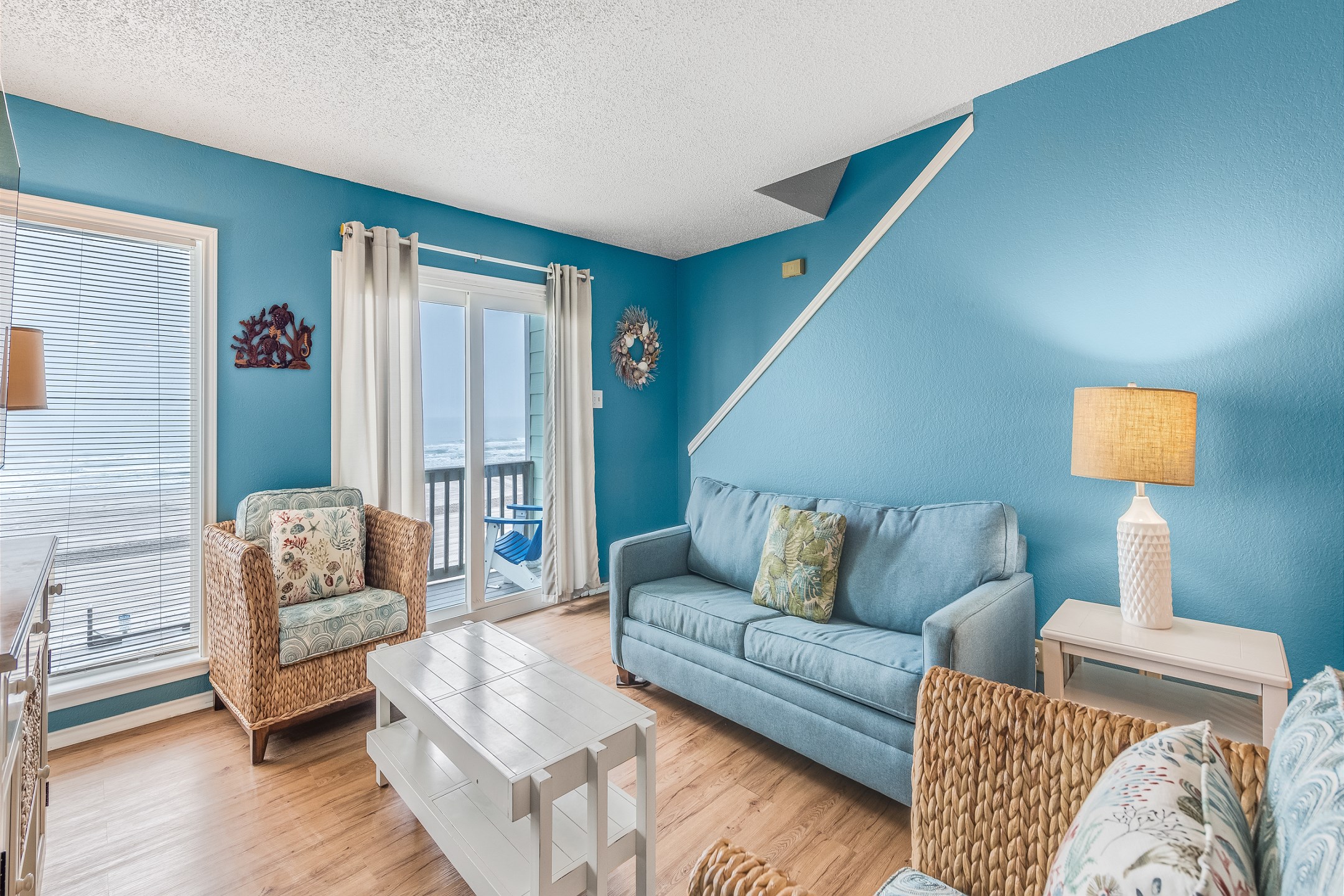 Cozy living space with large windows and views of the ocean