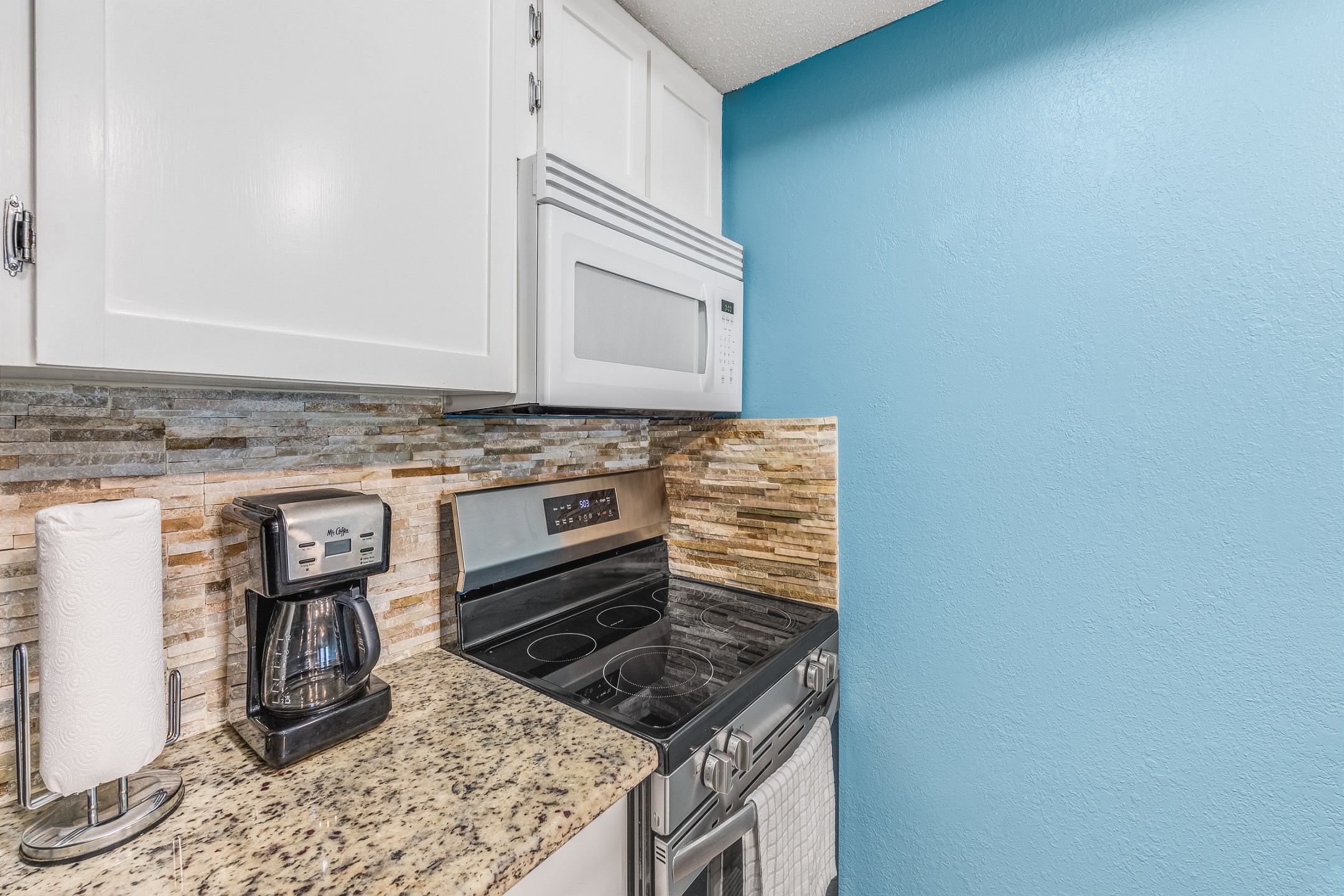 Kitchen area with new stainless steel appliances December 2024