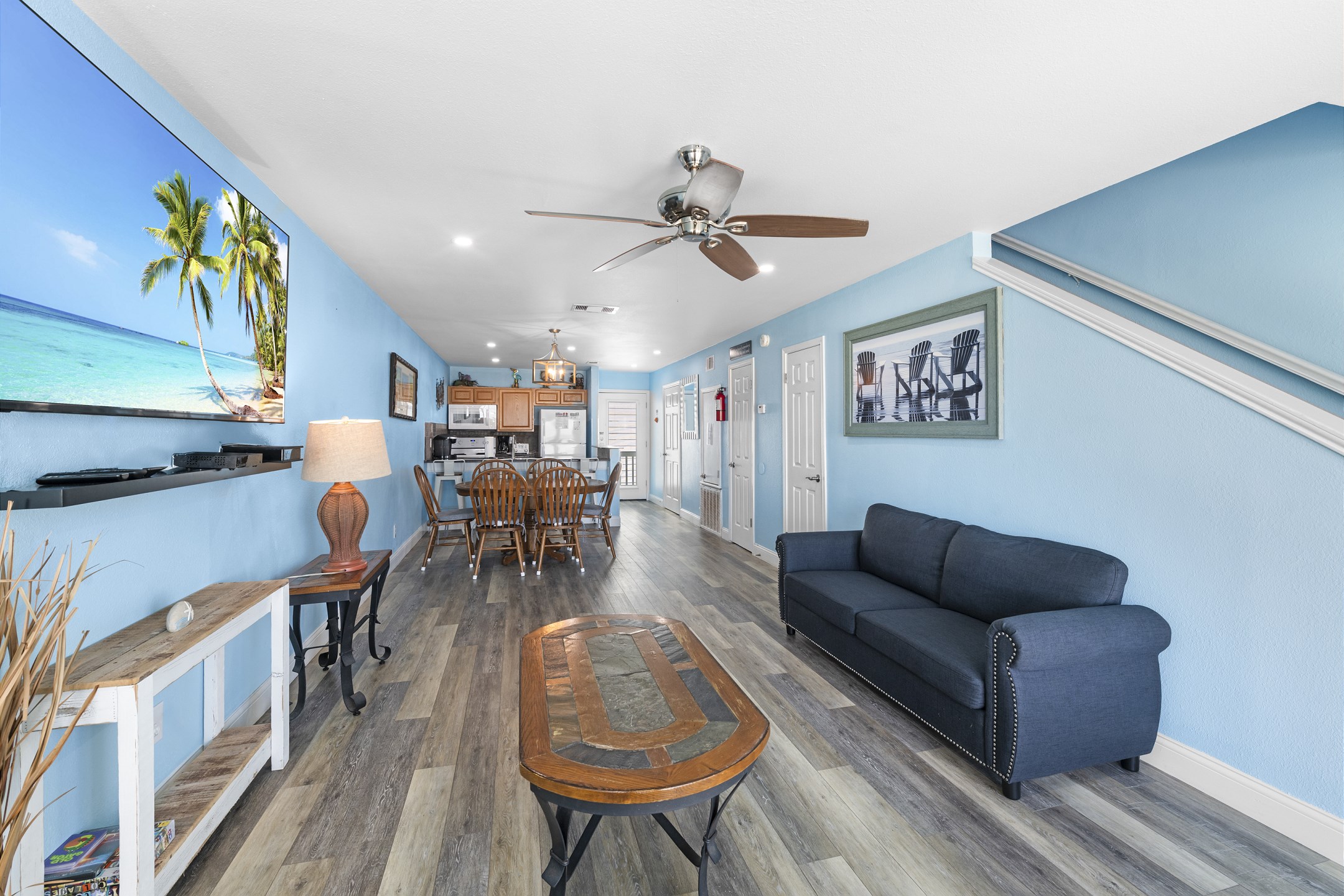 Open concept living space with coastal features throughout and cozy seating 