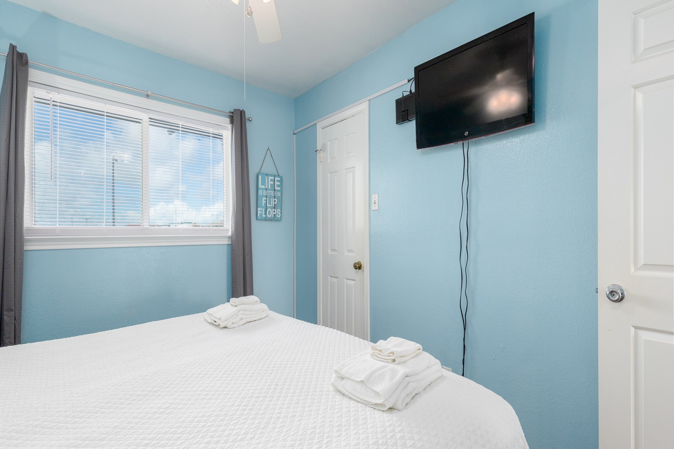 Master bedroom with king size bed and flat screen TV