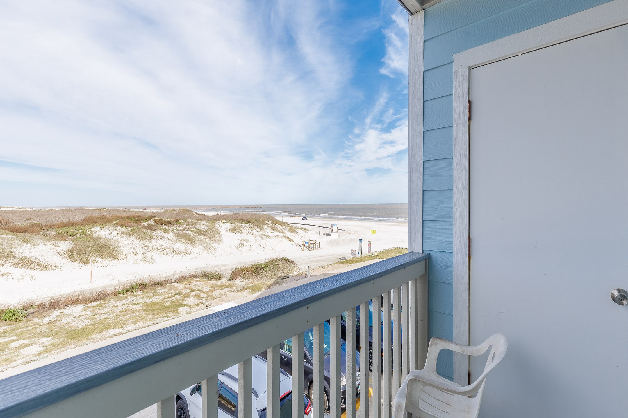 Private balcony off the kitchen, dining, and living area with a view of the dunes and beach