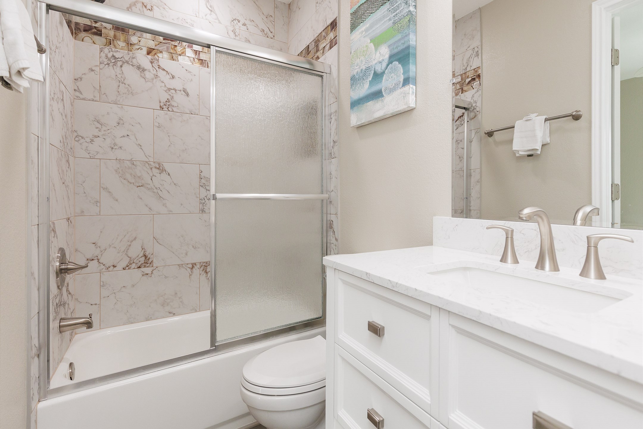 Guest bathroom on the second floor with tub and shower combo