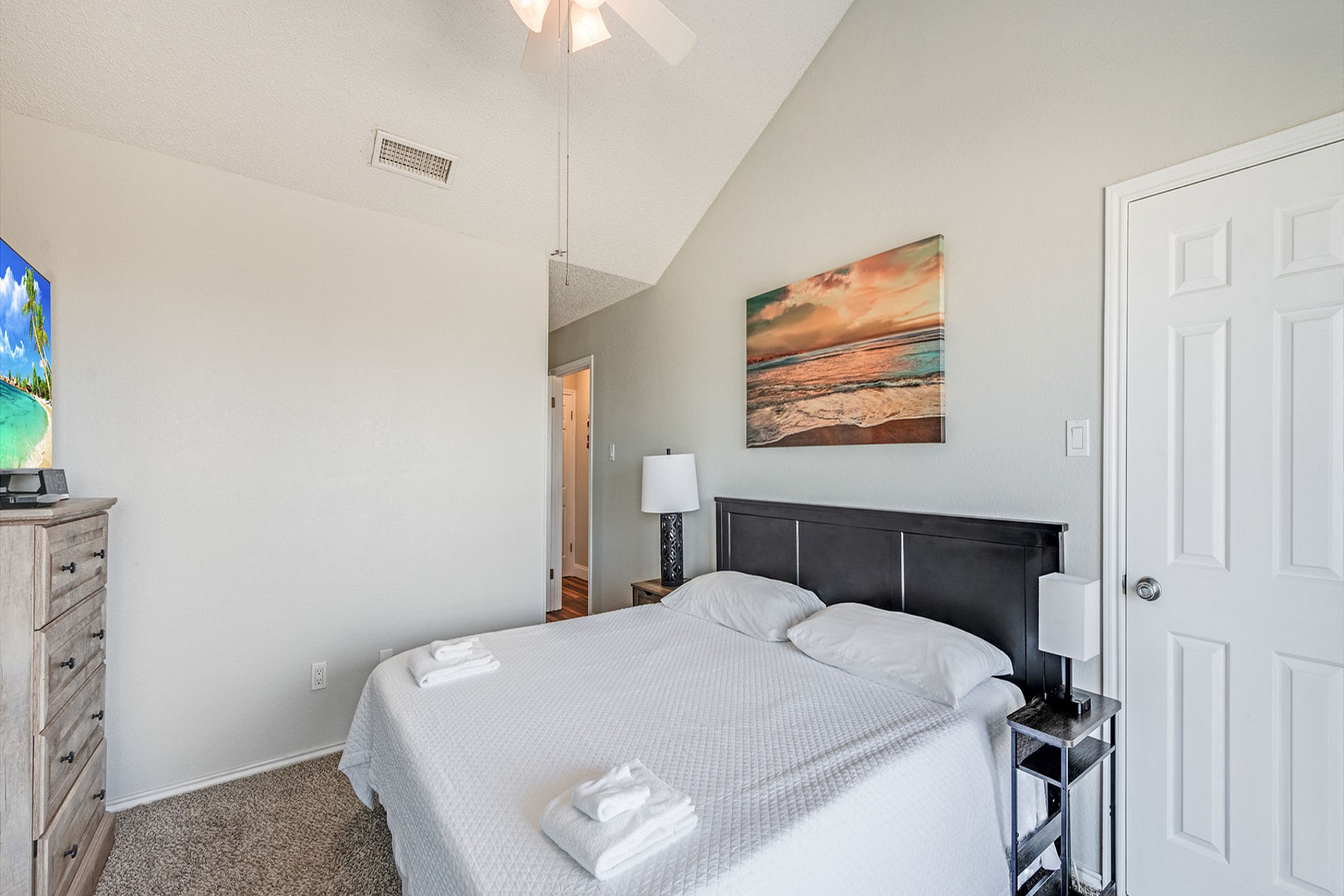 Second bedroom with queen size bed, private balcony, and flat screen TV