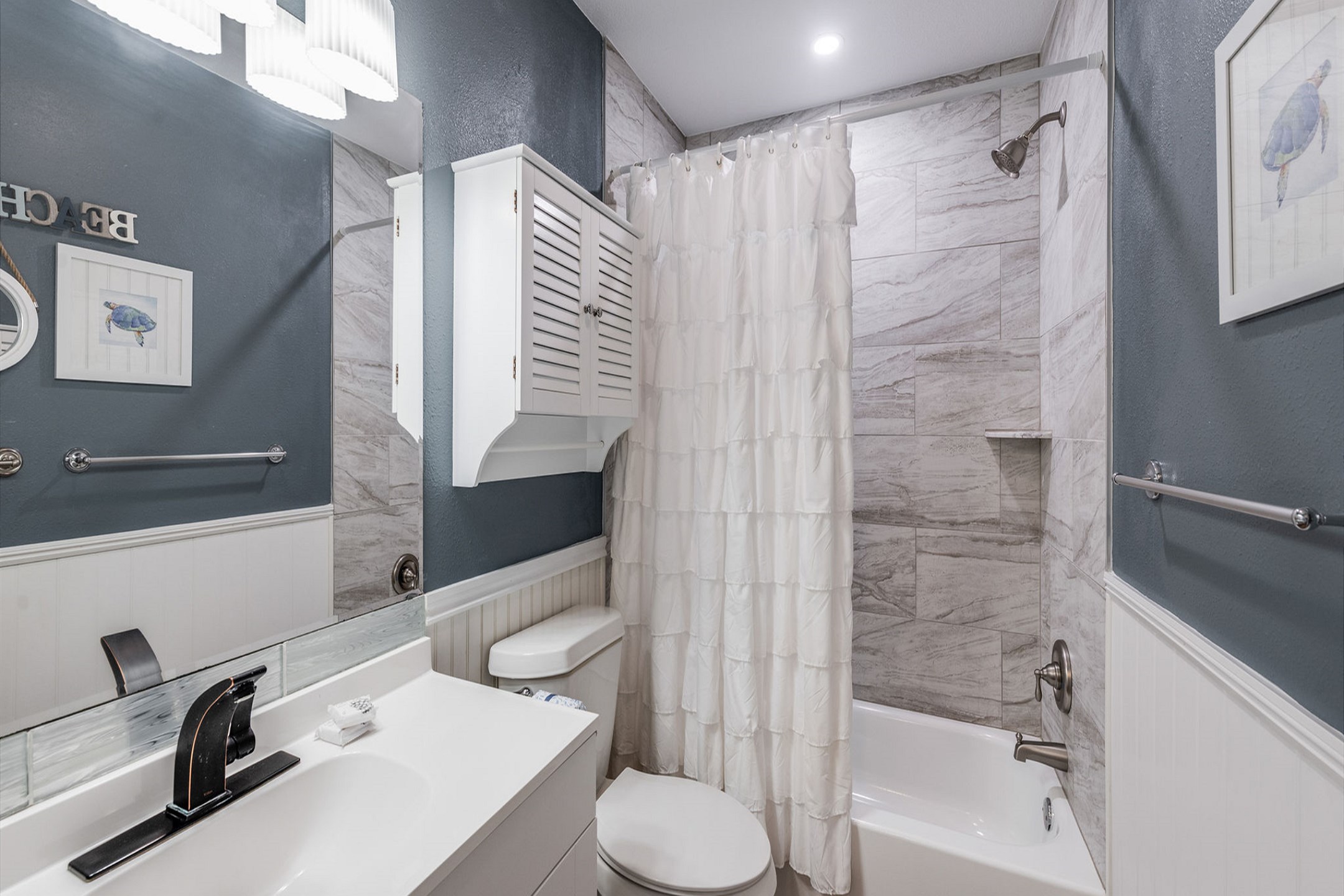 Guest bathroom with newly remodeled features and tub/shower combo