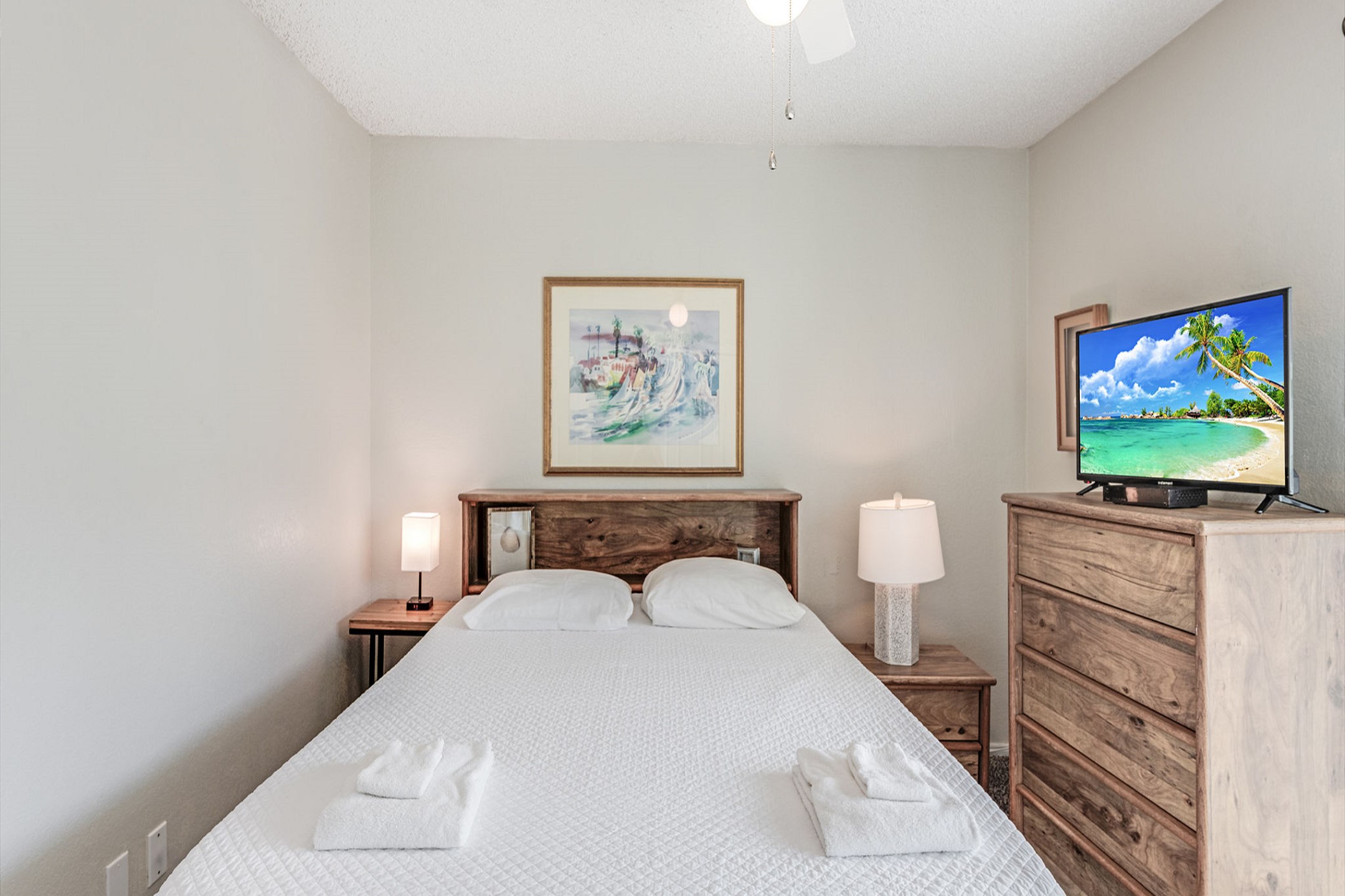 Second bedroom with queen size bed, private balcony, and flat screen TV