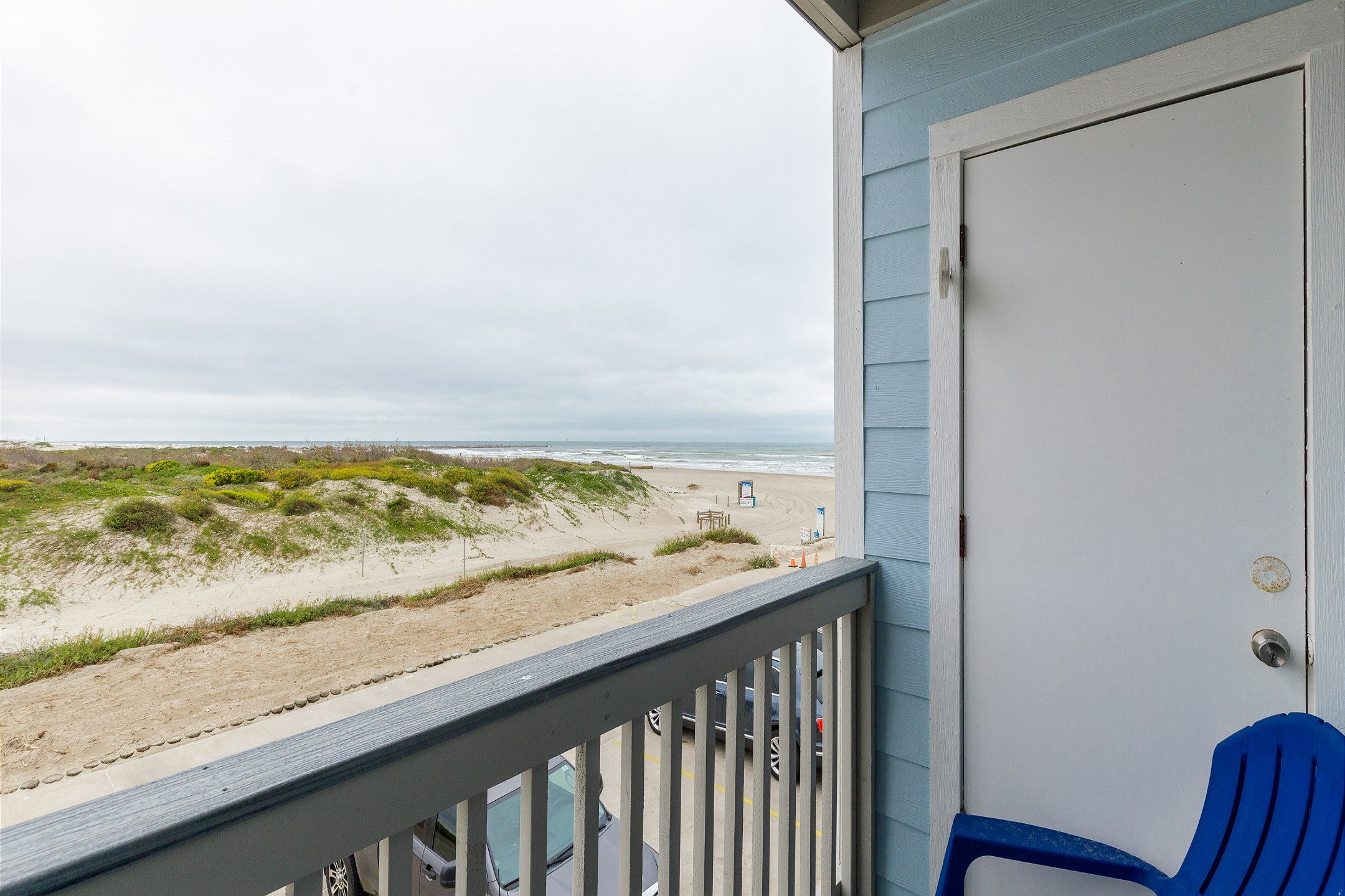 Private balcony off the living area with dune and beach views 