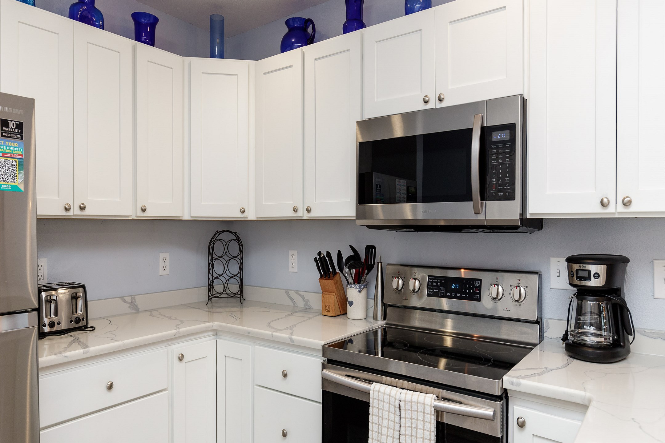 Coffee maker, toaster, cookware, dinnerware, and other kitchen essentials provided