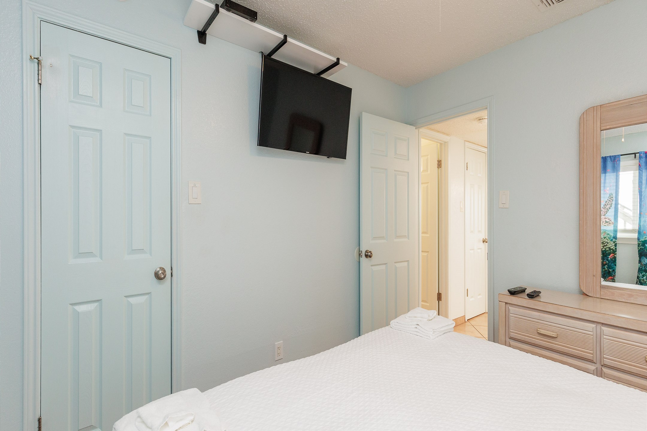 Master bedroom with king size bed and flat screen TV on wall mount swivel