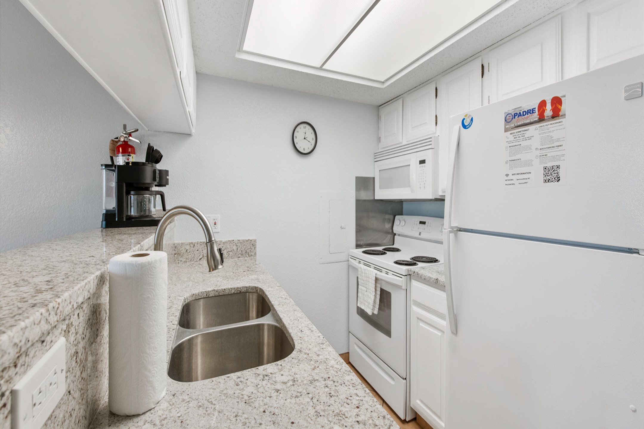 Fully equipped kitchen with lovely counter tops, appliances and coffee maker