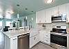 Fully equipped, updated kitchen with new appliances, hardwood floors and lighting 