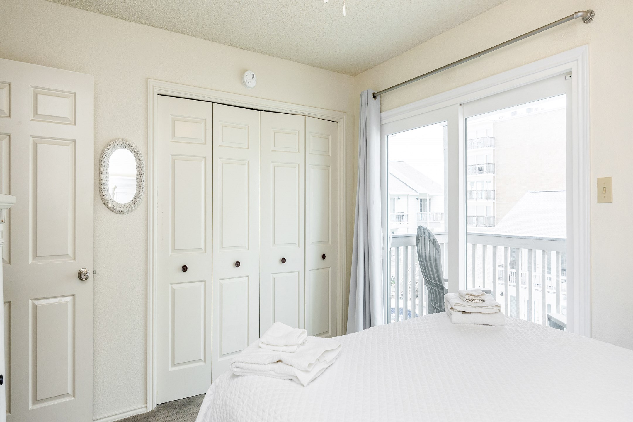 Second bedroom on the second floor with queen size bed, private balcony, and flat screen TV