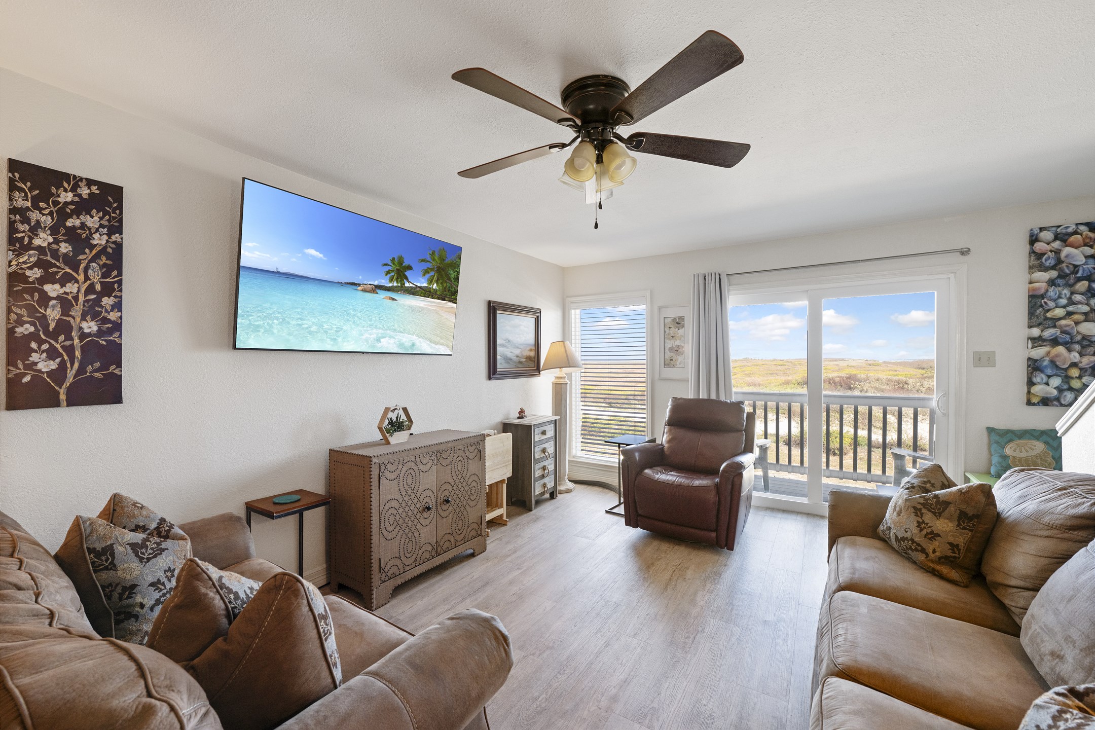 Enjoy watching the big game on the 65in Smart TV in the living area with the natural light shinning in through the windows