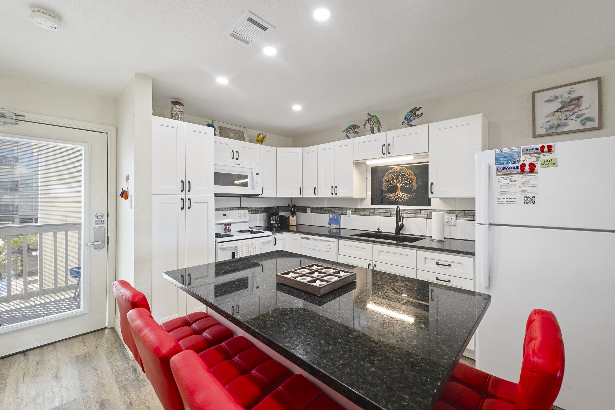 Beautifully remodel kitchen with updated Island, granite counter tops and full white cabinets - Perfect space to cook meals with the family