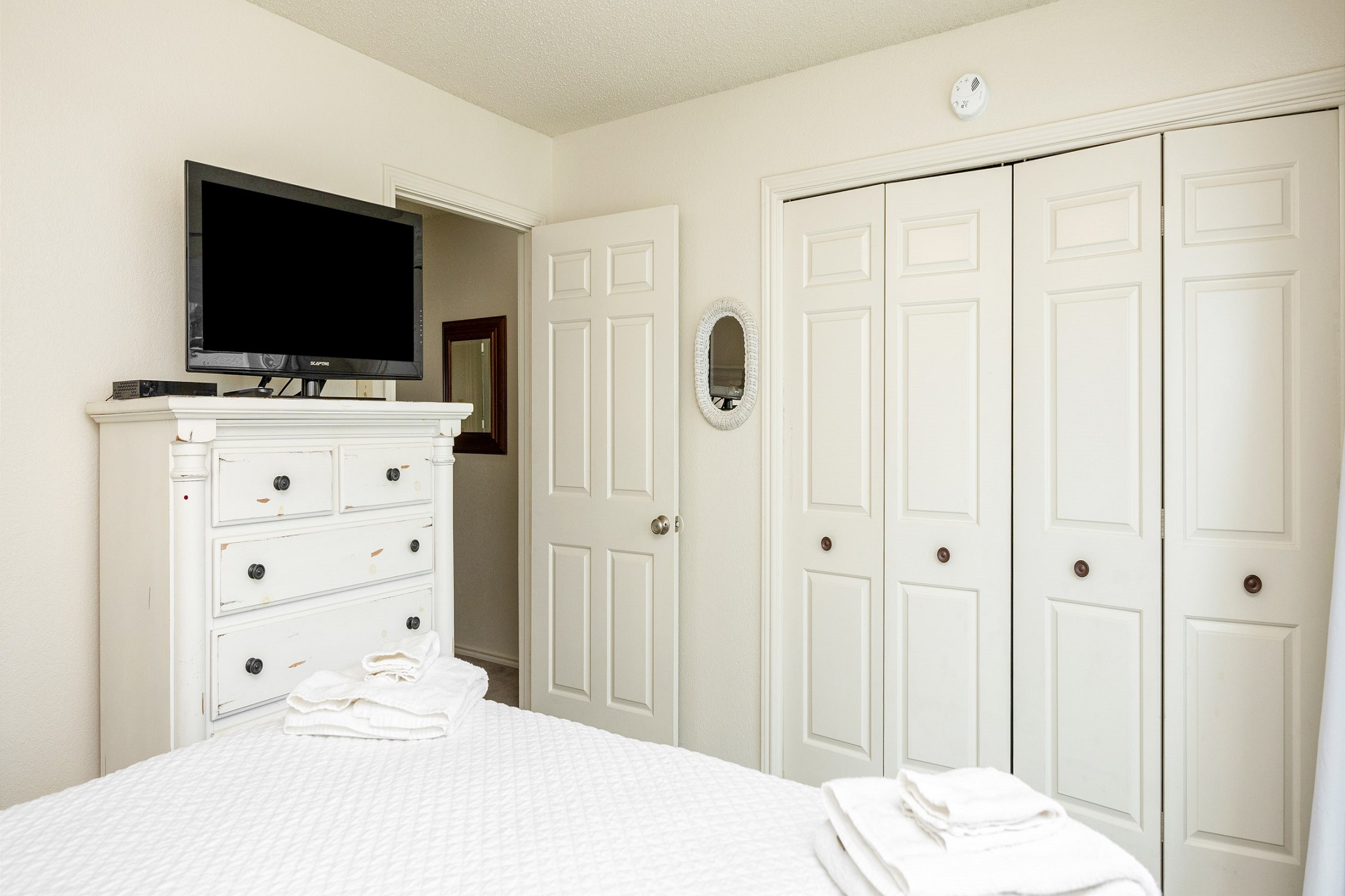 Second bedroom on the second floor with queen size bed, private balcony, and flat screen TV