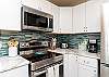 Fully equipped kitchen with new tile backsplash and 12-cup coffee maker 