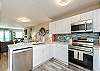 Fully equipped kitchen with stainless steel appliances and new tile backsplash 