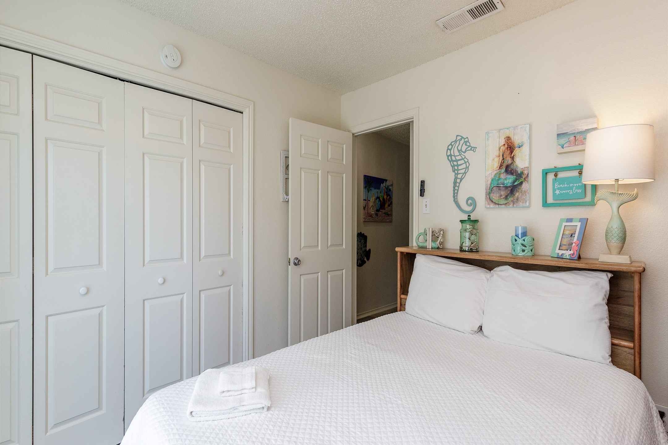 Second bedroom on the second floor with a queen size bed, twin size bunk bed, and twin trundle bed, includes a private balcony and flat screen TV